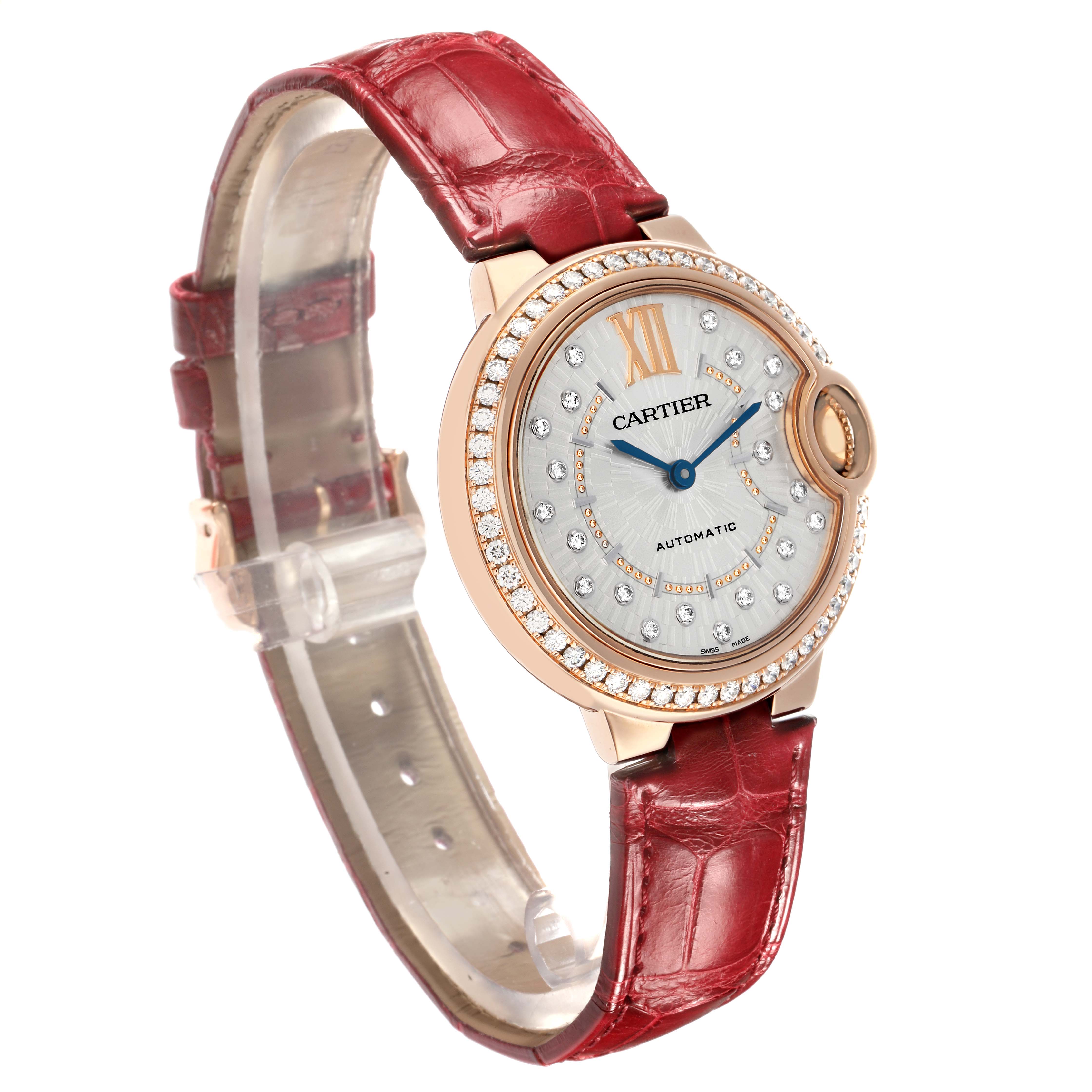 The Cartier Ballon Bleu WJBB0080 Women
s Rose Gold Silver Dial watch is shown at a slight angle, displaying its face, bezel, and red leather strap.