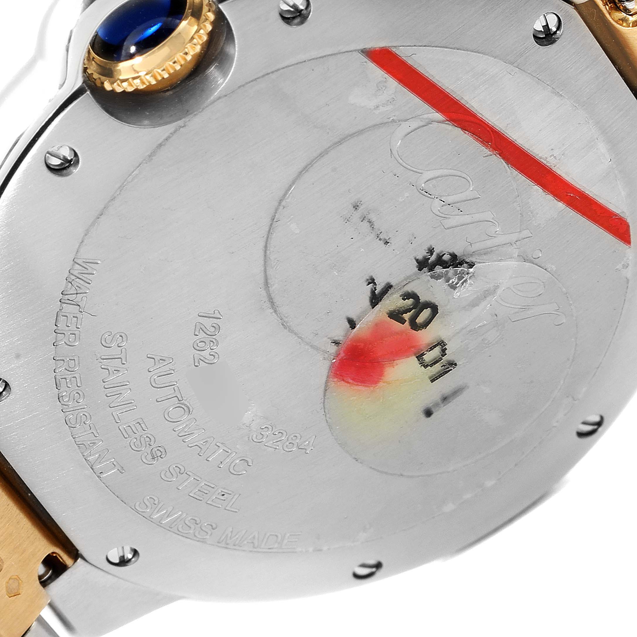 The image shows the backside of a Cartier Ballon Bleu W2BB0012 Men
s Steel and Gold (two tone) Silver Dial W2BB0012 Men
s Steel and Gold (two tone) Silver Dial watch, displaying details like the brand name, water resistance, and automatic movement.