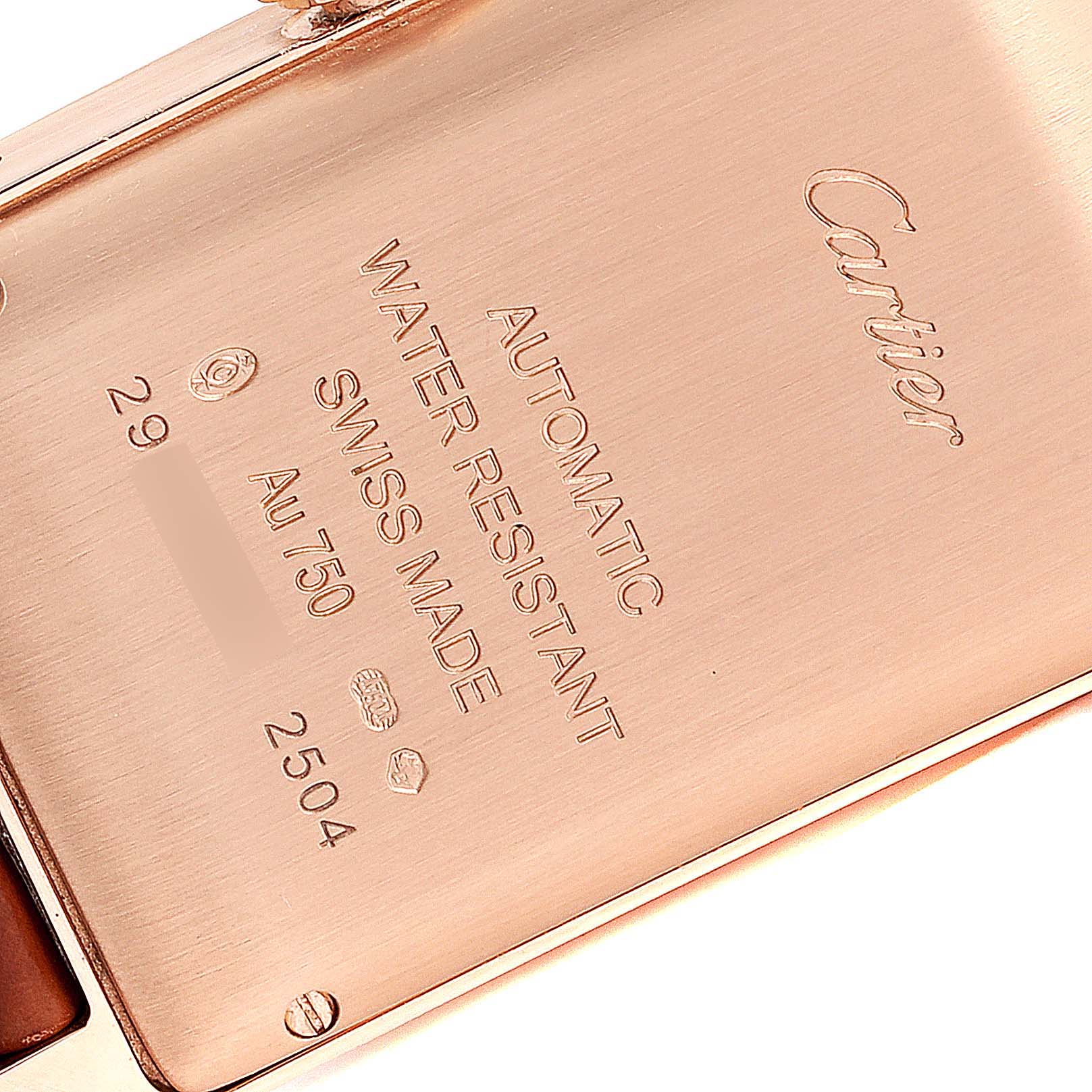 This image shows the back case of a Cartier Tank Américaine watch, highlighting engravings and hallmarks.