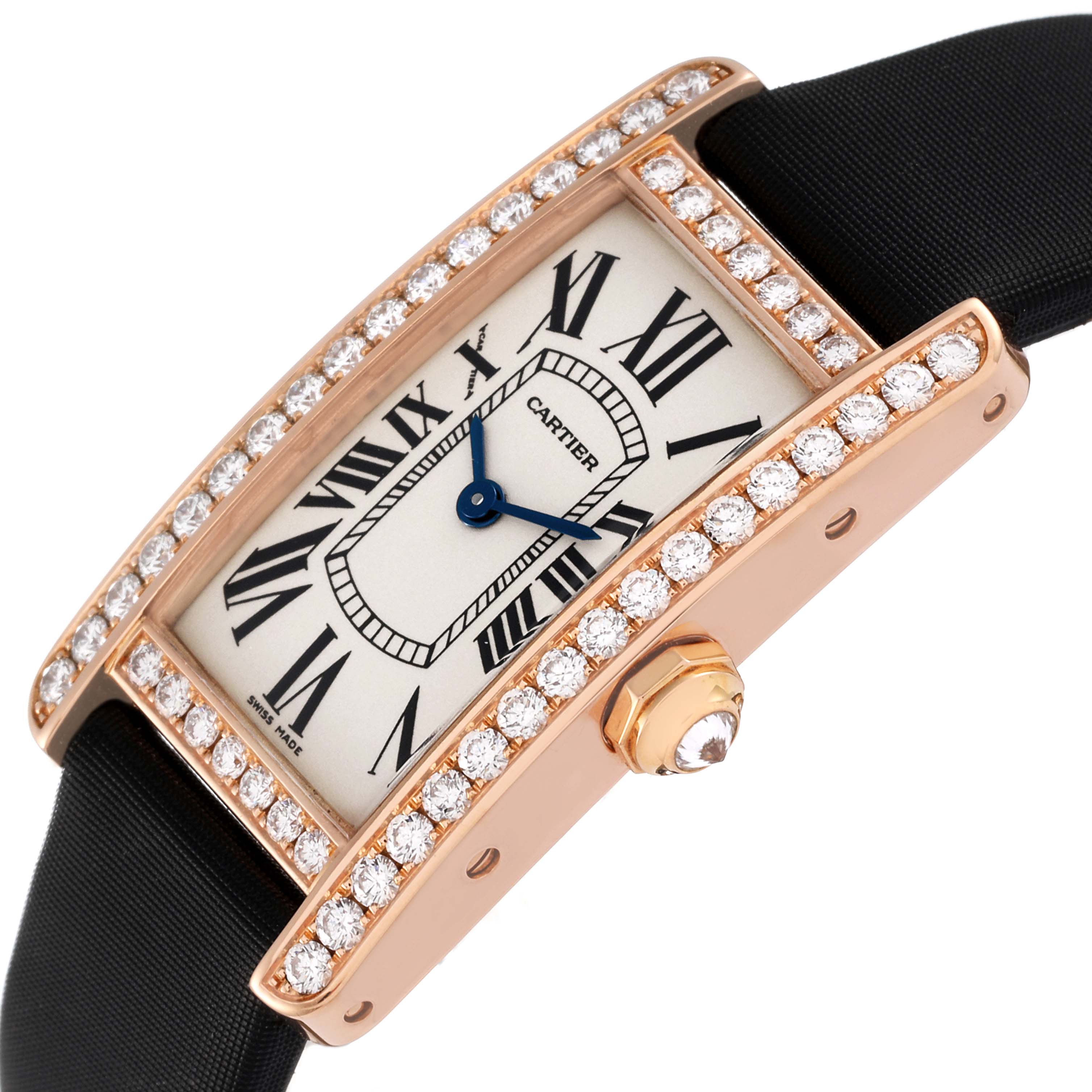 The image shows an angled view of the Cartier Tank Americaine WJTA0002 Women's Rose Gold Silver Dial WJTA0002 Women's Rose Gold Silver Dial watch, featuring diamond-set bezel, Roman numeral dial, and a black strap.