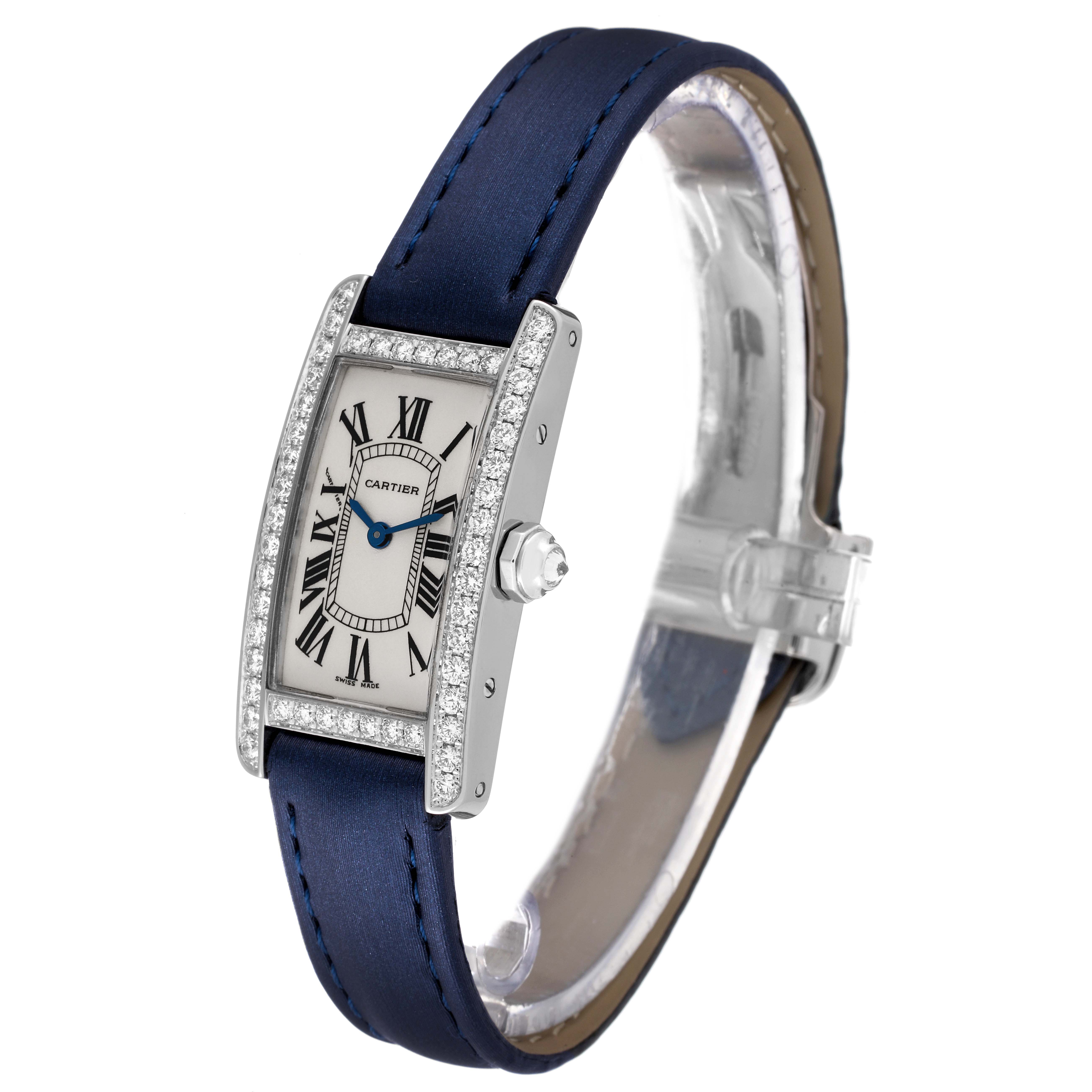 The Cartier Tank Americaine WB7018L1 Women's White Gold Silver Dial WB7018L1 Women's White Gold Silver Dial watch is shown at a slight angle, displaying its face, bezel, blue strap, and crown.