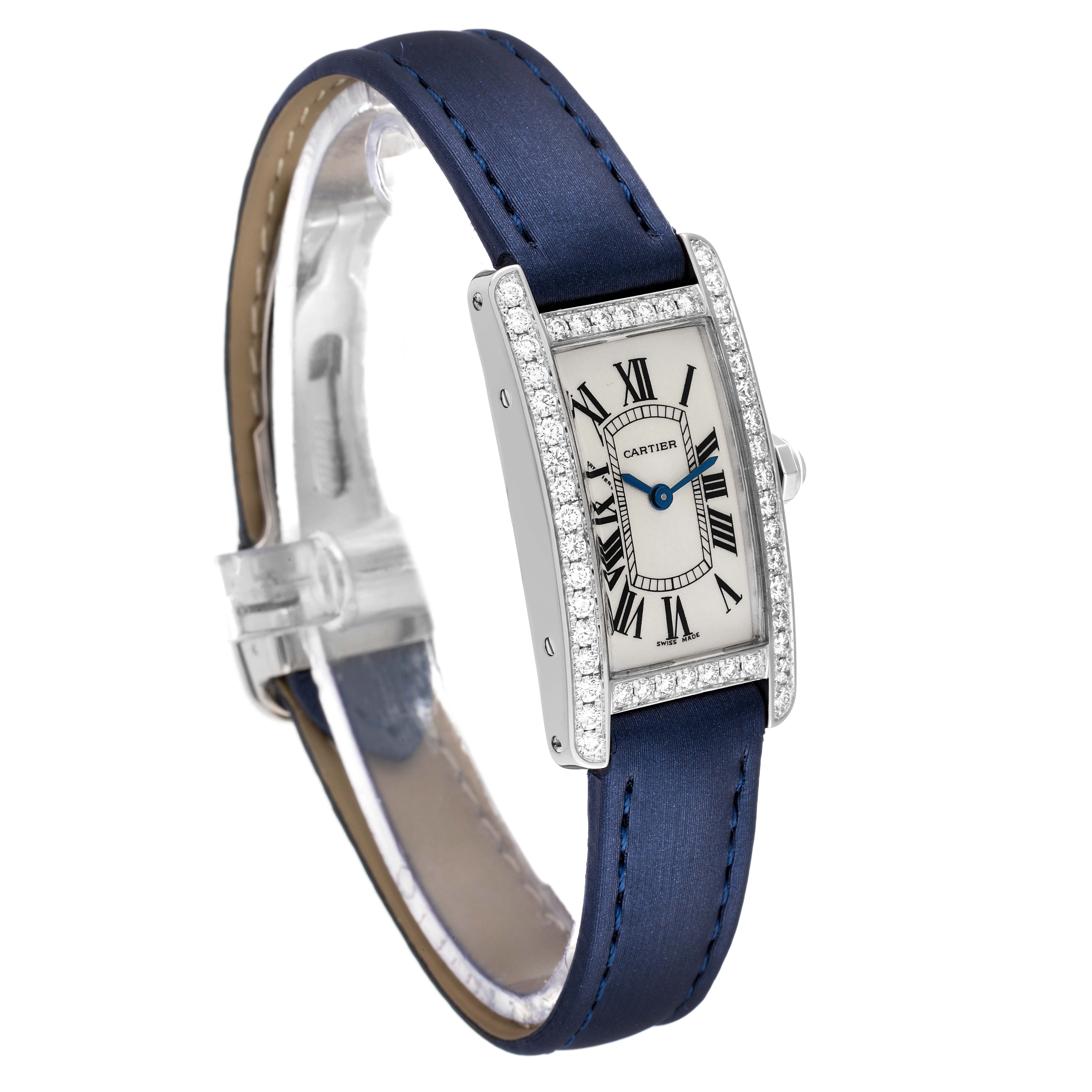 The Cartier Tank Americaine WB7018L1 Women's White Gold Silver Dial WB7018L1 Women's White Gold Silver Dial watch is shown at a three-quarter angle, highlighting its rectangular face, blue strap, and diamond-set bezel.