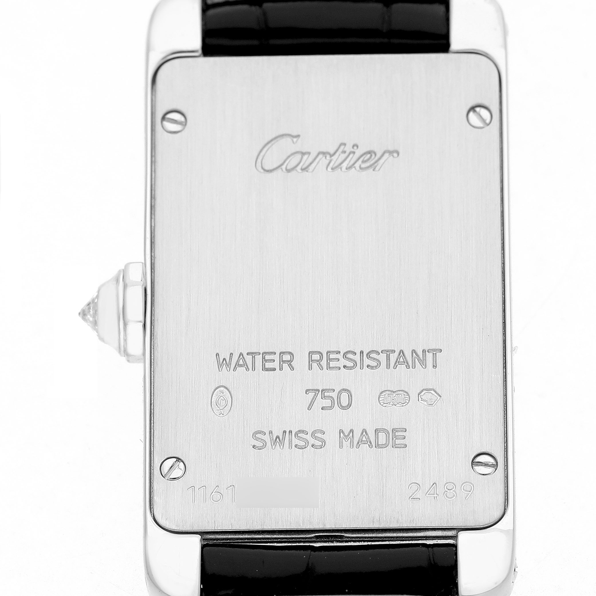 The image shows the back of a Cartier Tank Americaine WB707331 Women's White Gold Silver Dial watch, displaying engravings and part of the strap.