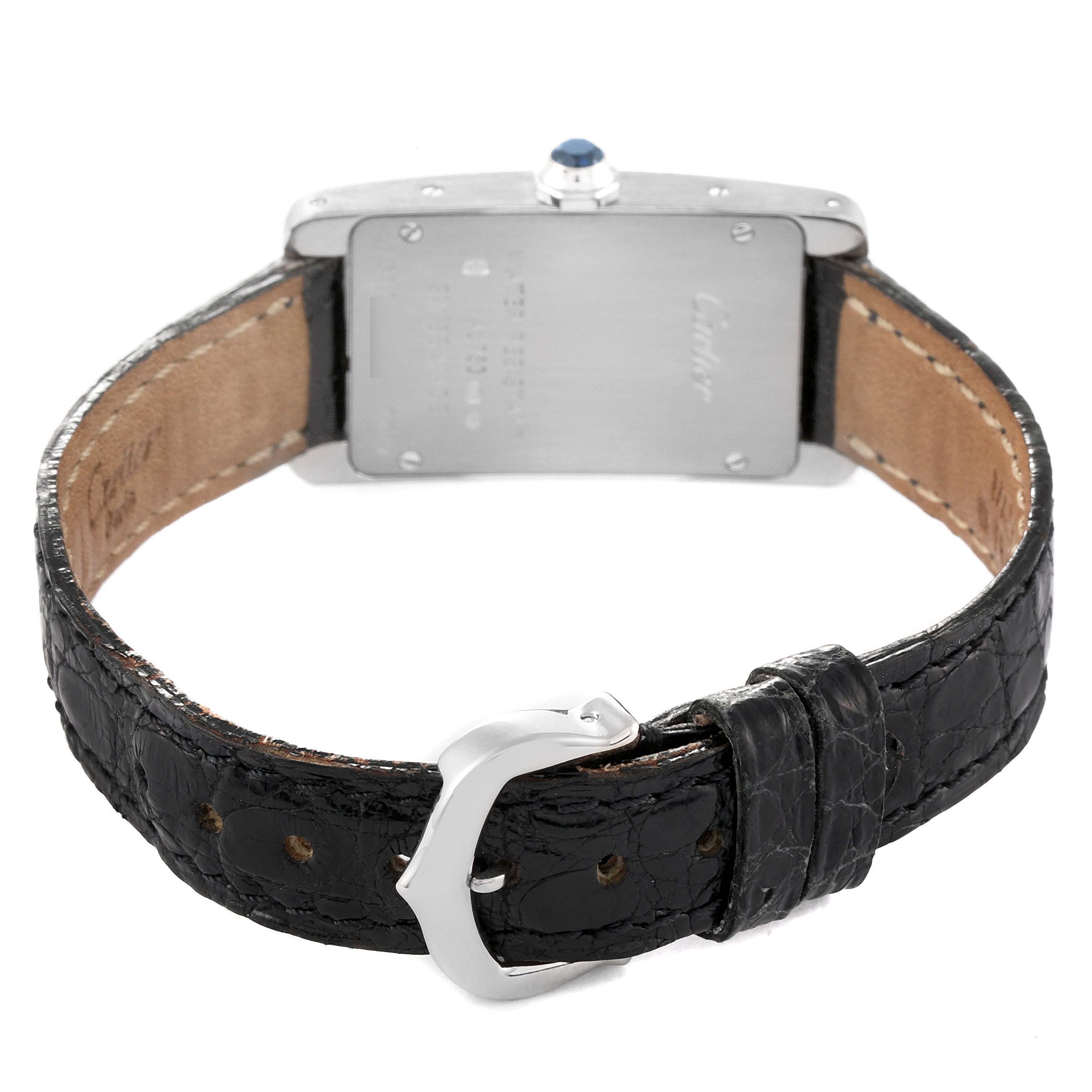 The image shows the back of the Tank Americaine model by Cartier, including the leather strap, buckle, and back casing with a crown gem.