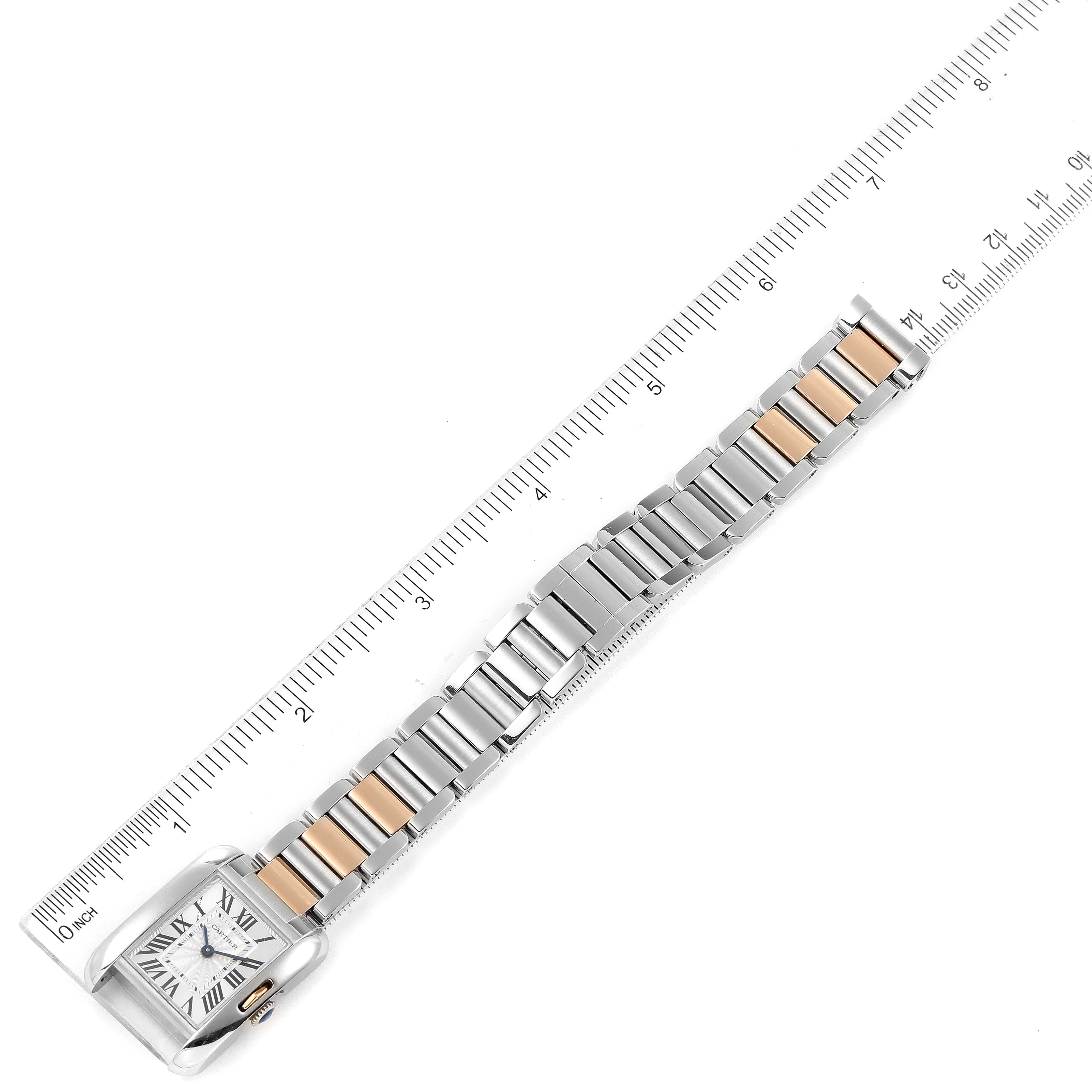 The image shows a Cartier Tank Anglaise W5310036 Women's Steel and Gold (two tone) Silver Dial W5310036 Women's Steel and Gold (two tone) Silver Dial watch laid flat, emphasizing its face and metal bracelet next to a ruler for scale.