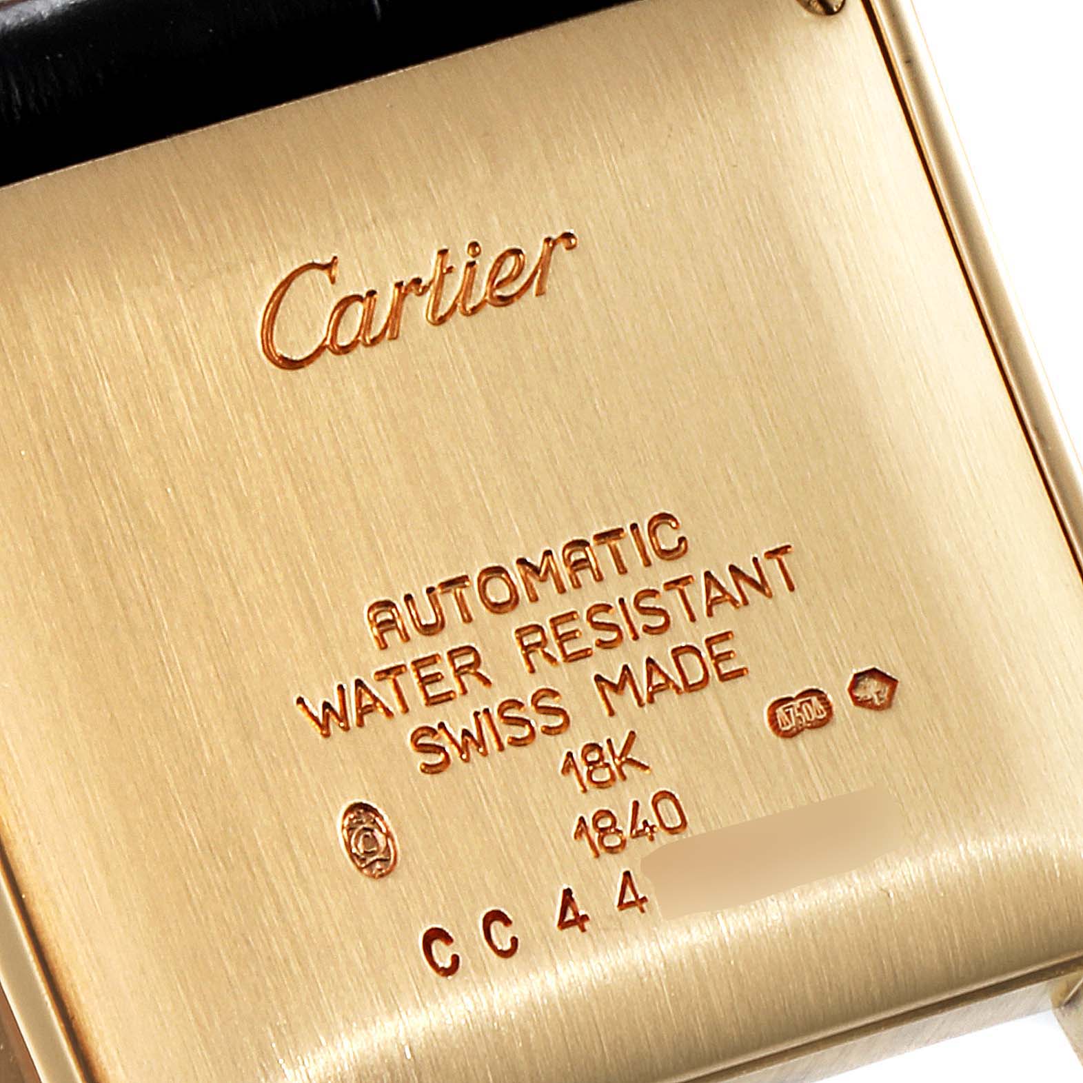 This image shows the engraved back case of a Cartier Tank Francaise W5000156 Men's Yellow Gold Silver Dial W5000156 Men's Yellow Gold Silver Dial watch, detailing specifications and brand markings.