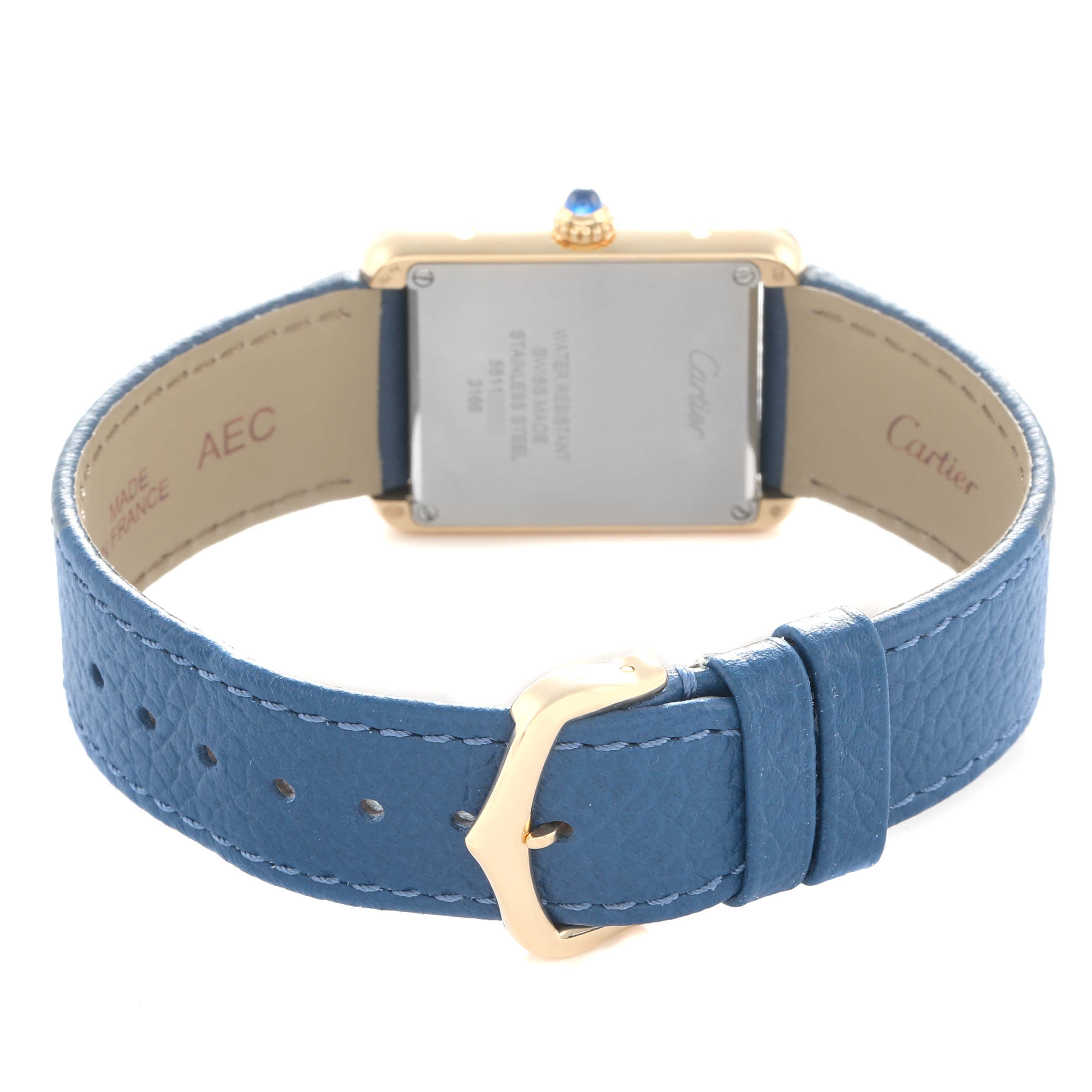 The image shows the back of the Cartier Tank Solo W5200002 Women
s Yellow Gold Silver Dial watch, focusing on the case back, blue strap, and gold buckle.
