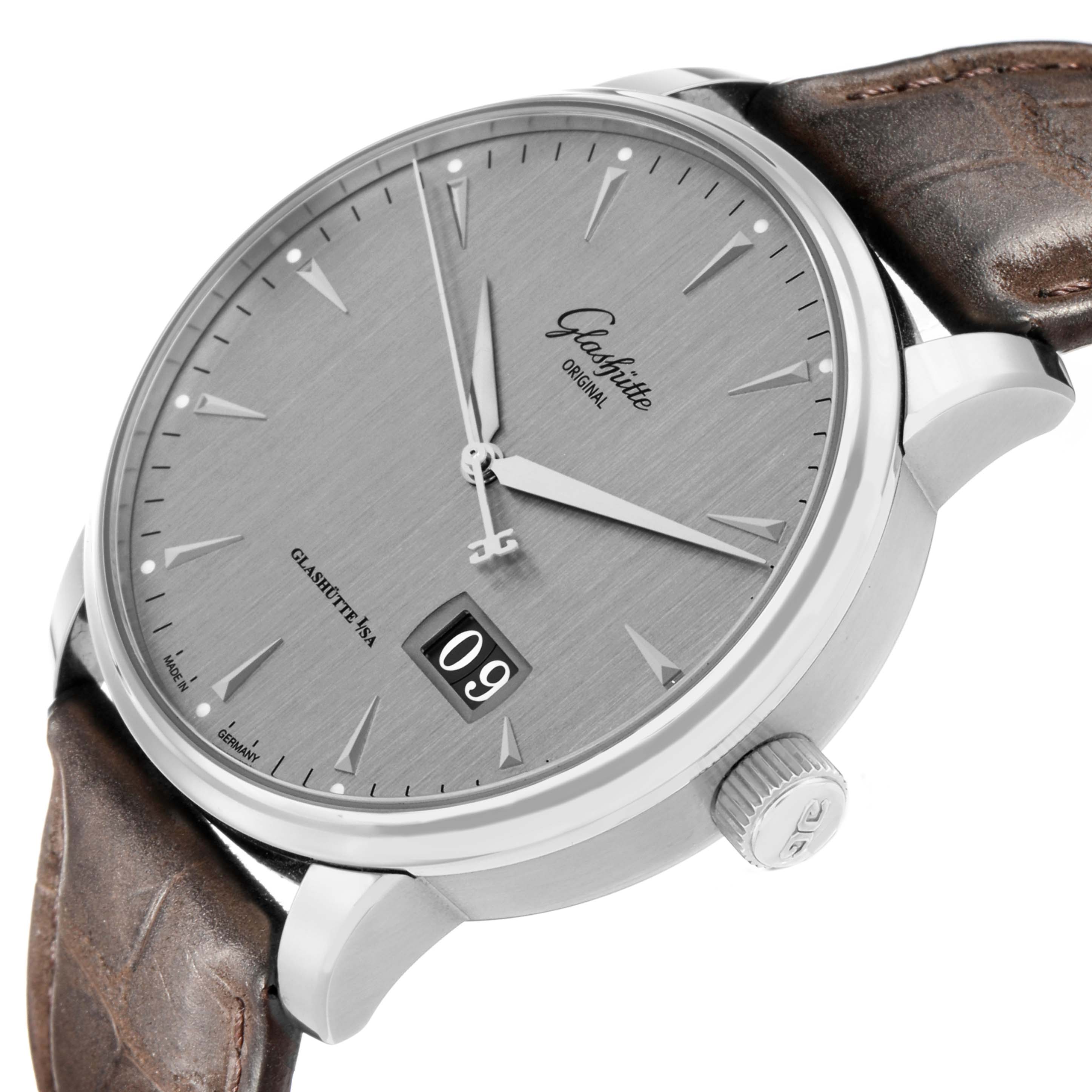 The Glashütte Senator watch is shown at an angled close-up, highlighting the dial, date display, crown, and leather strap.