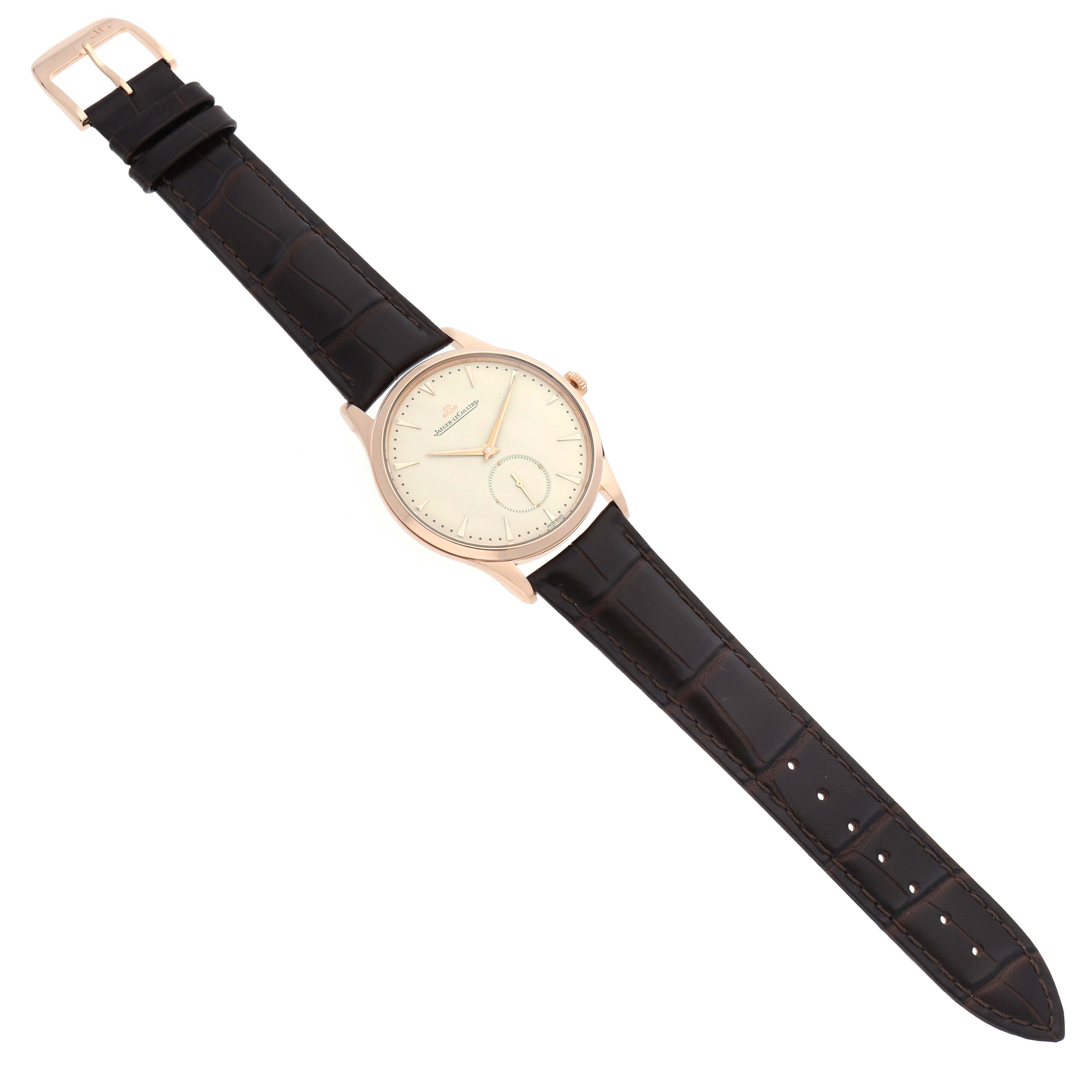 The Jaeger LeCoultre Master Q1352520 Men
s Rose Gold Beige Dial watch is shown from a top angle, featuring the face and leather strap.