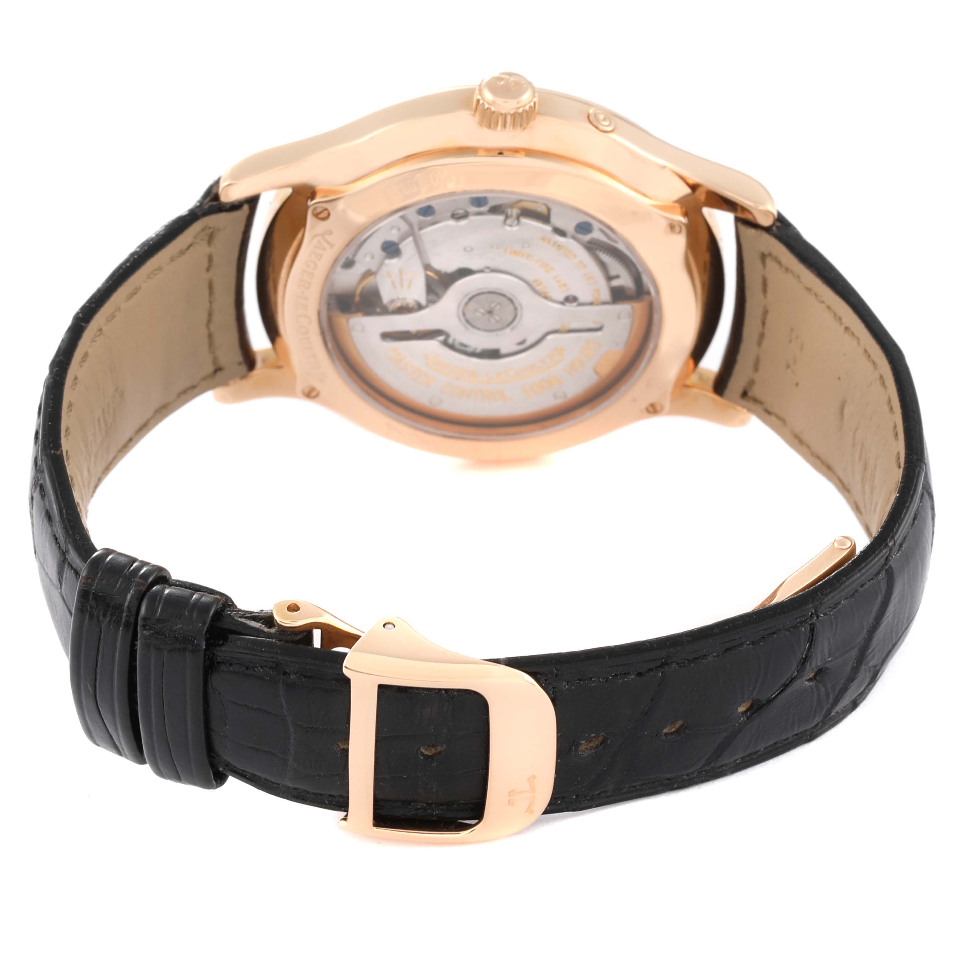 The image shows the back view of a Jaeger-LeCoultre Master model watch, highlighting the movement mechanism and leather strap.