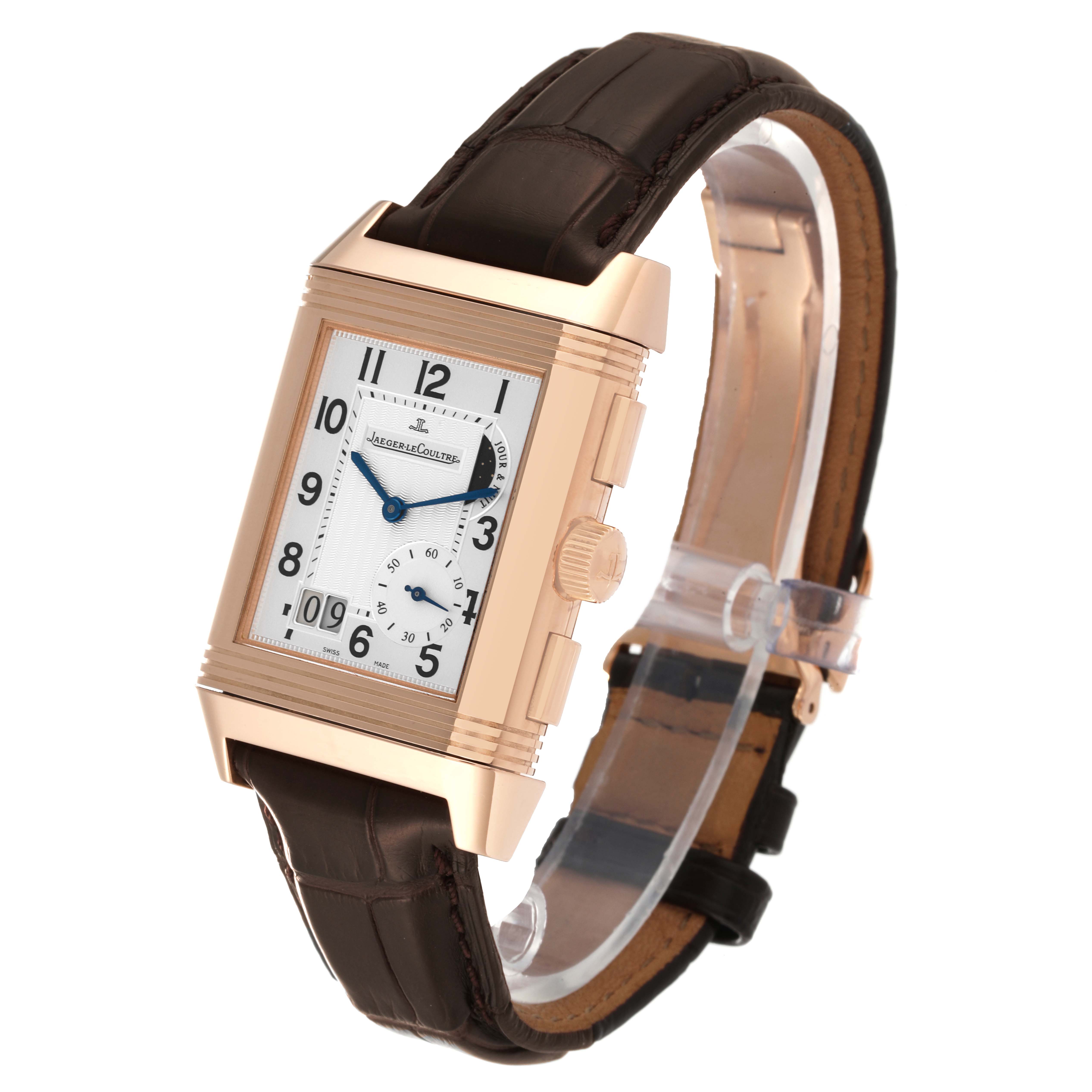 The image shows a Jaeger LeCoultre Reverso Q3022420 Men's Rose Gold Silver Dial Q3022420 Men's Rose Gold Silver Dial watch from a front-side angle, highlighting the rectangular dial and leather strap.