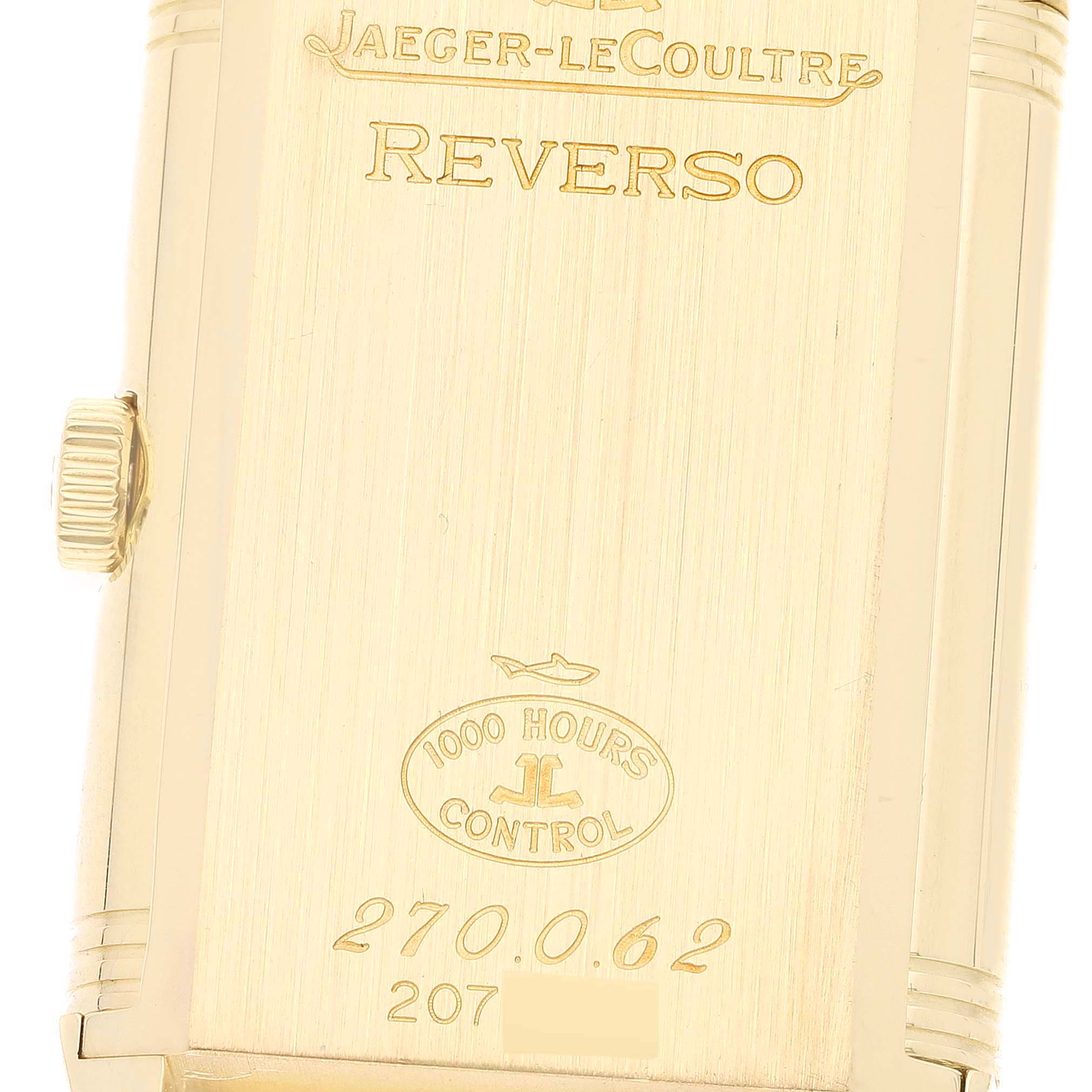 This image shows the back case of a Jaeger-LeCoultre Reverso watch, featuring brand engravings and a knurled crown.
