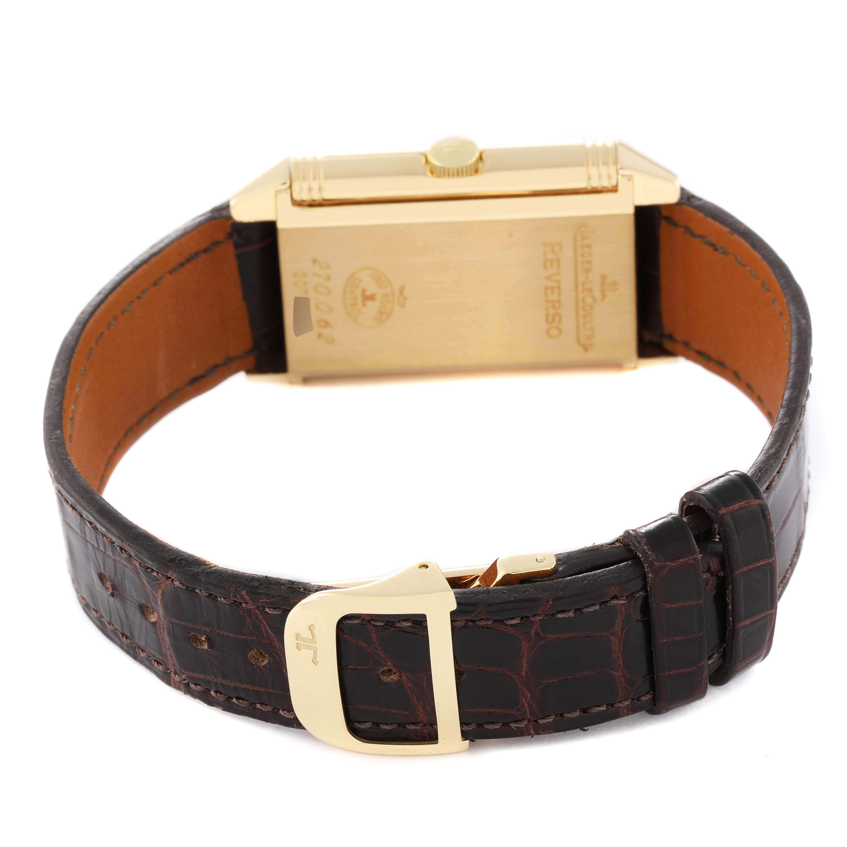 The image shows the back view of a Jaeger-LeCoultre Reverso watch, displaying its case back, crown, and leather strap with buckle.