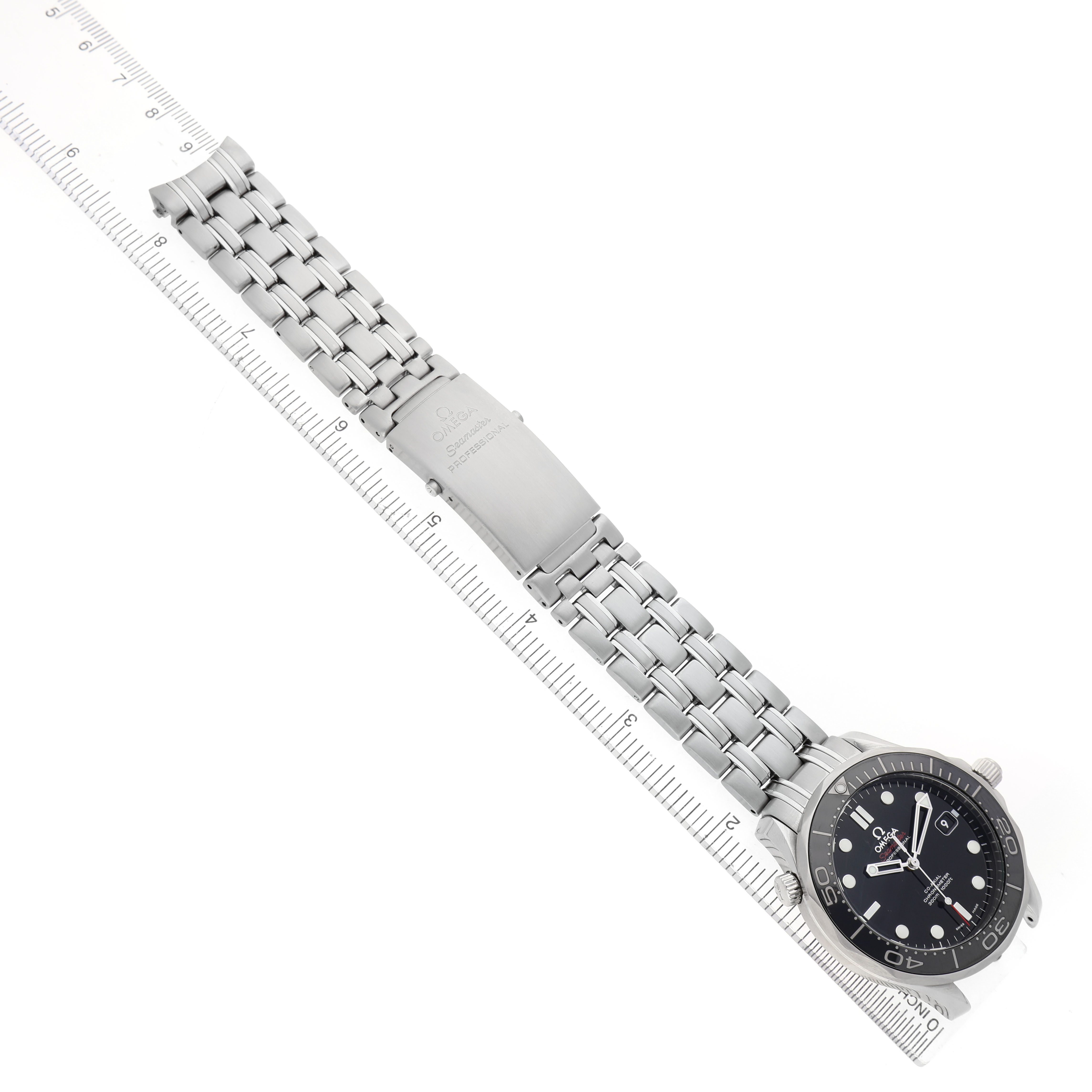 The Omega Seamaster 212.30.41.20.01.003 Men's Stainless Steel Black Dial watch is shown at an angle highlighting its bracelet and clasp, alongside a ruler for scale.