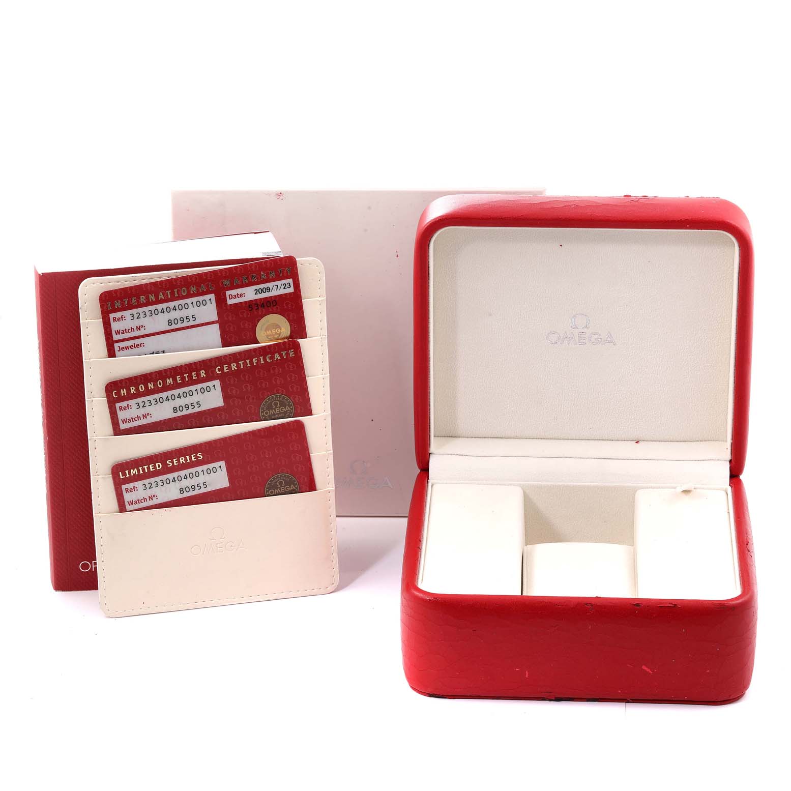 The image shows an Omega Speedmaster 323.30.40.40.01.001 Men's Stainless Steel Black Dial 323.30.40.40.01.001 Men's Stainless Steel Black Dial watch's red box, instruction booklet, and certification cards holder.