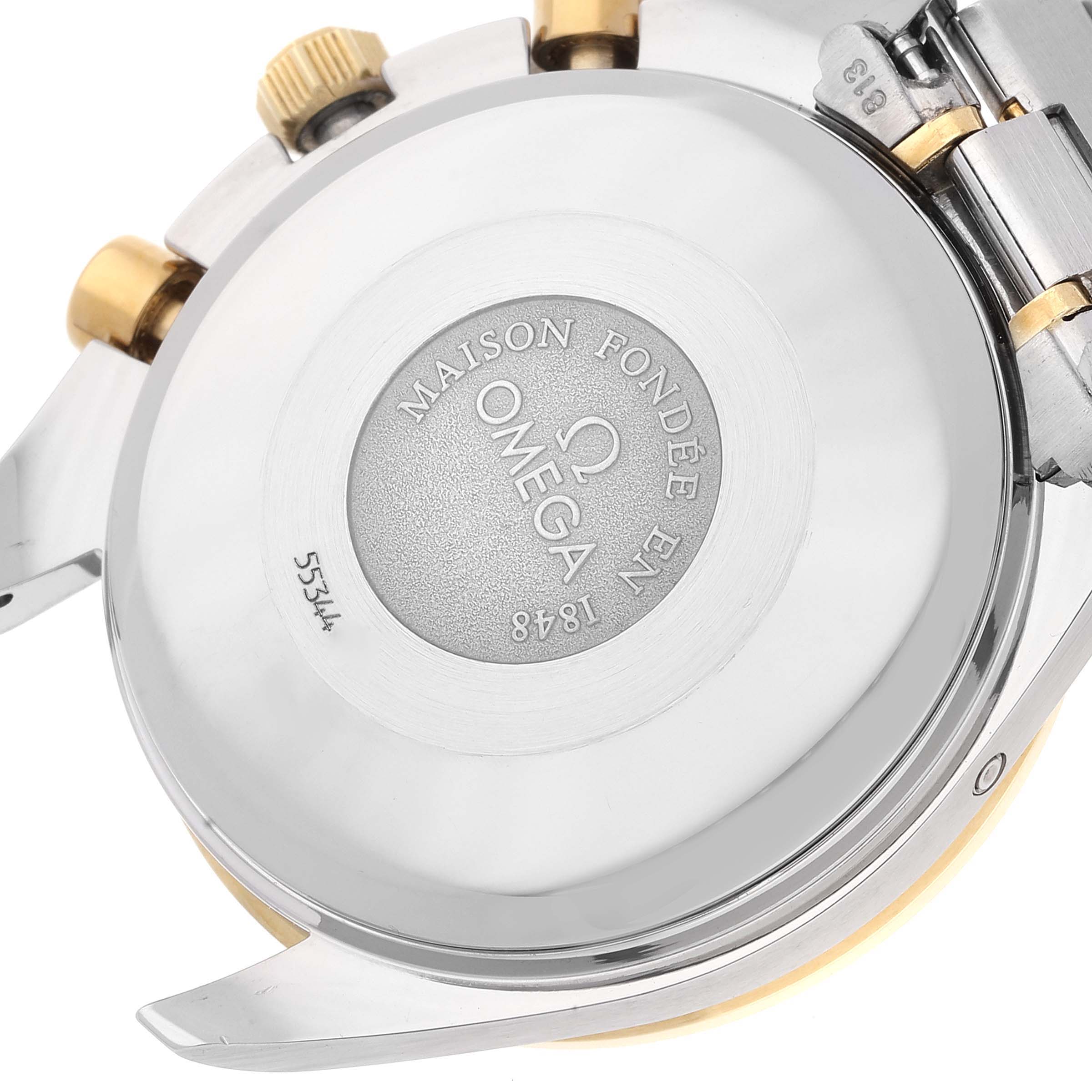 The image shows the stainless steel case back and part of the bracelet of an Omega Speedmaster 3321.80.00 Men's Steel and Gold (two tone) Blue Dial 3321.80.00 Men's Steel and Gold (two tone) Blue Dial watch, viewed from the rear angle.