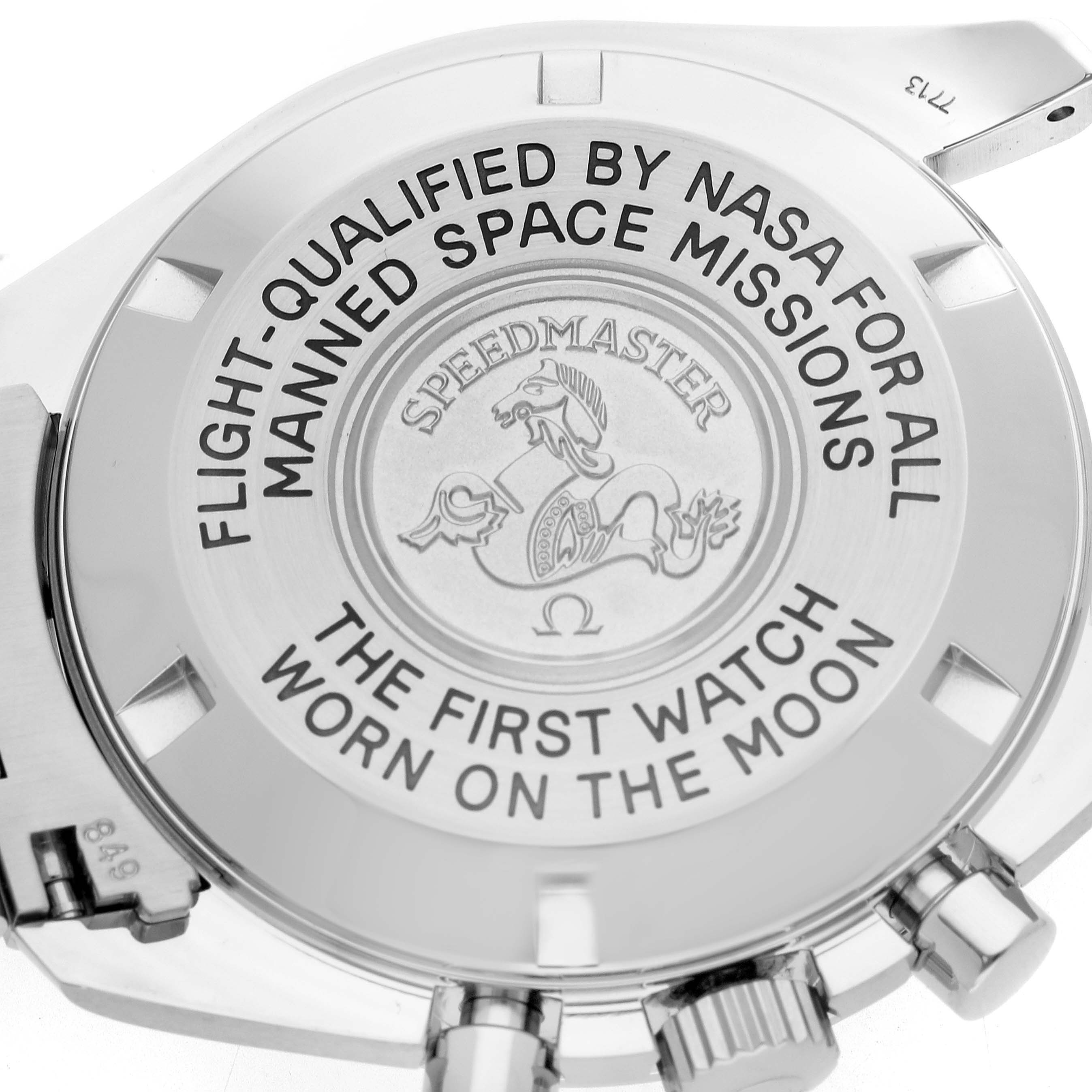 The image shows the case back of an Omega Speedmaster 3570.50.00 Men
s Stainless Steel Black Dial, highlighting inscriptions and the emblem.