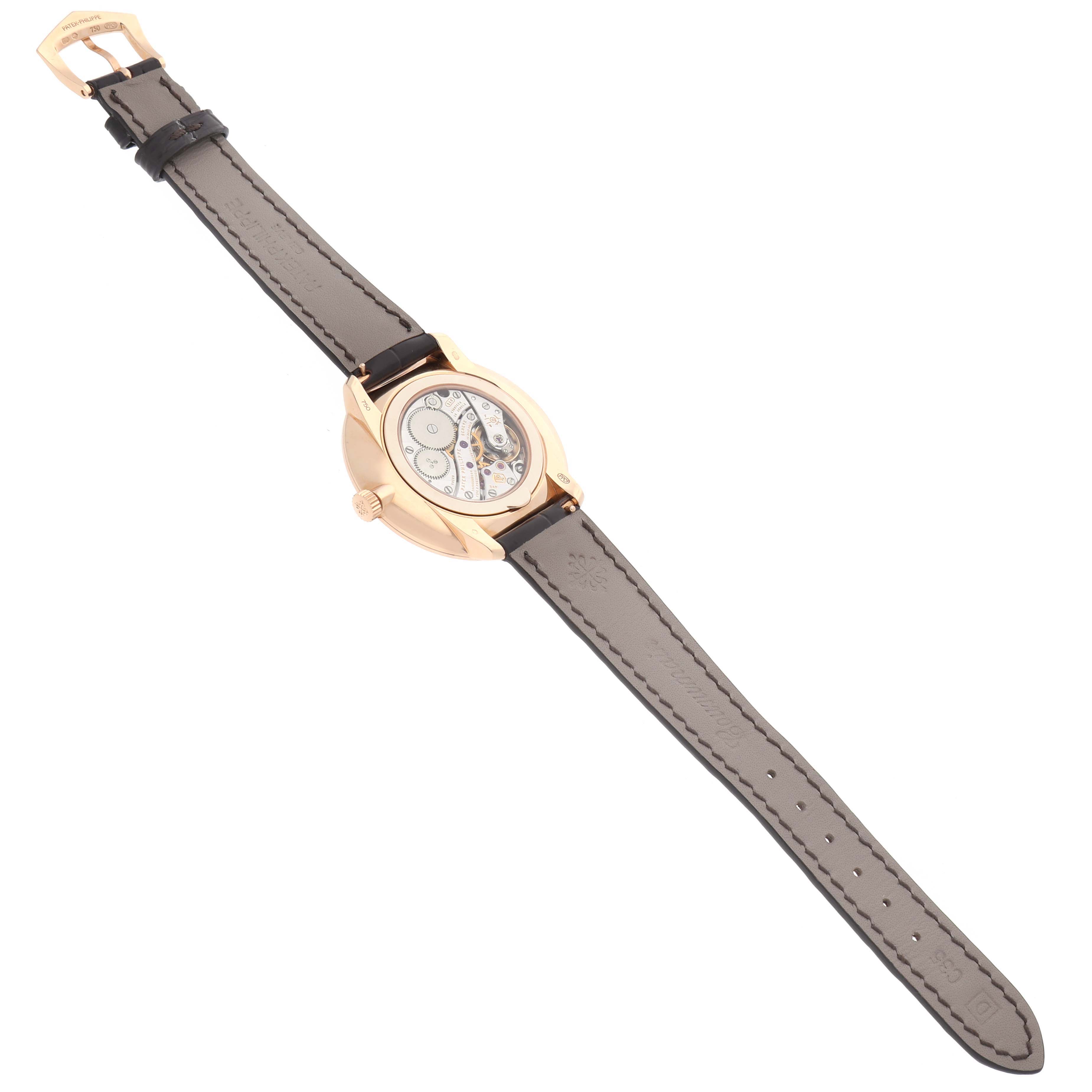 The Patek Philippe Calatrava 5123 Men
s Rose Gold Silver Dial watch is shown from a rear angle, displaying its movement and leather strap.