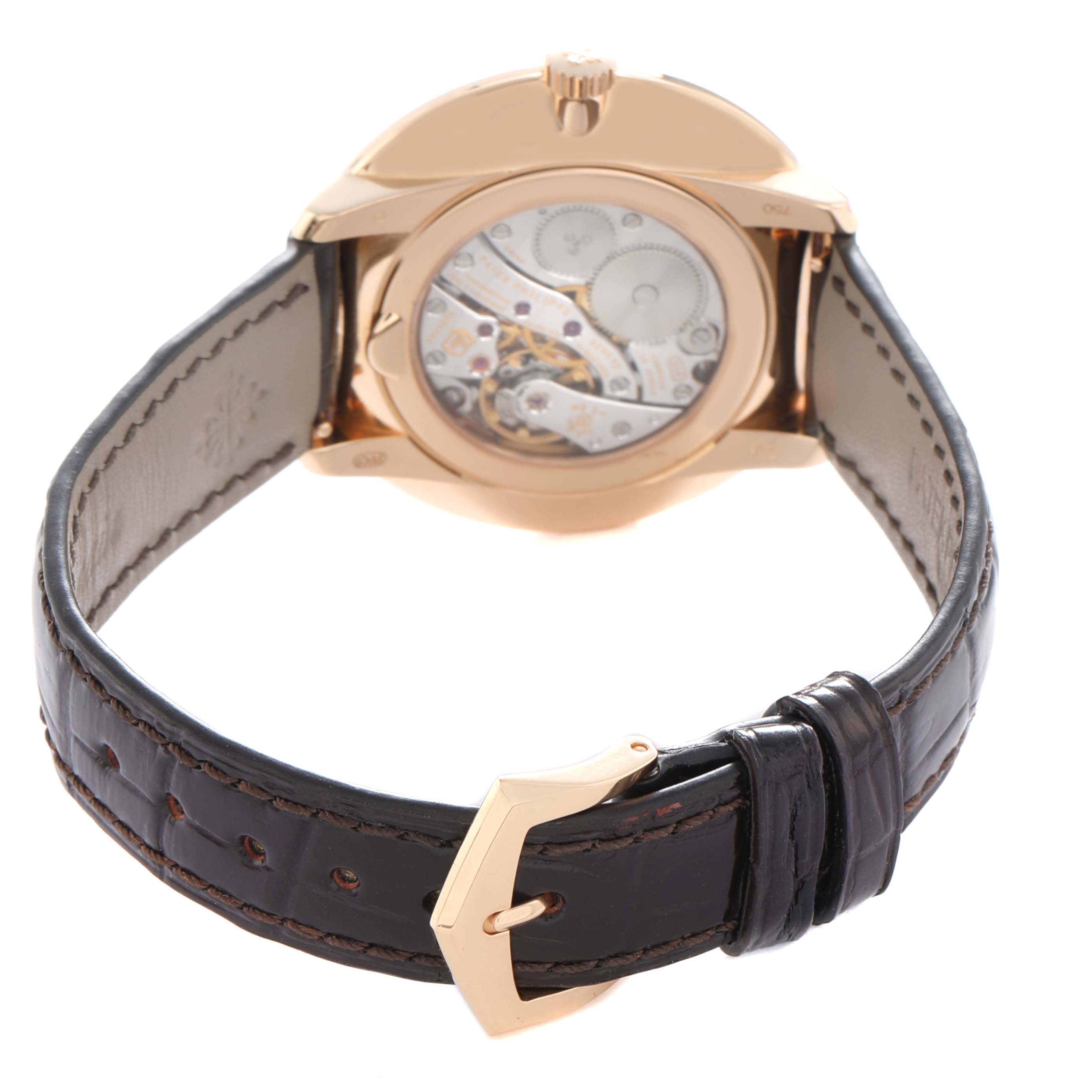 The Patek Philippe Calatrava 5123 Men
s Rose Gold Silver Dial watch is shown from the back, highlighting its transparent caseback and leather strap.