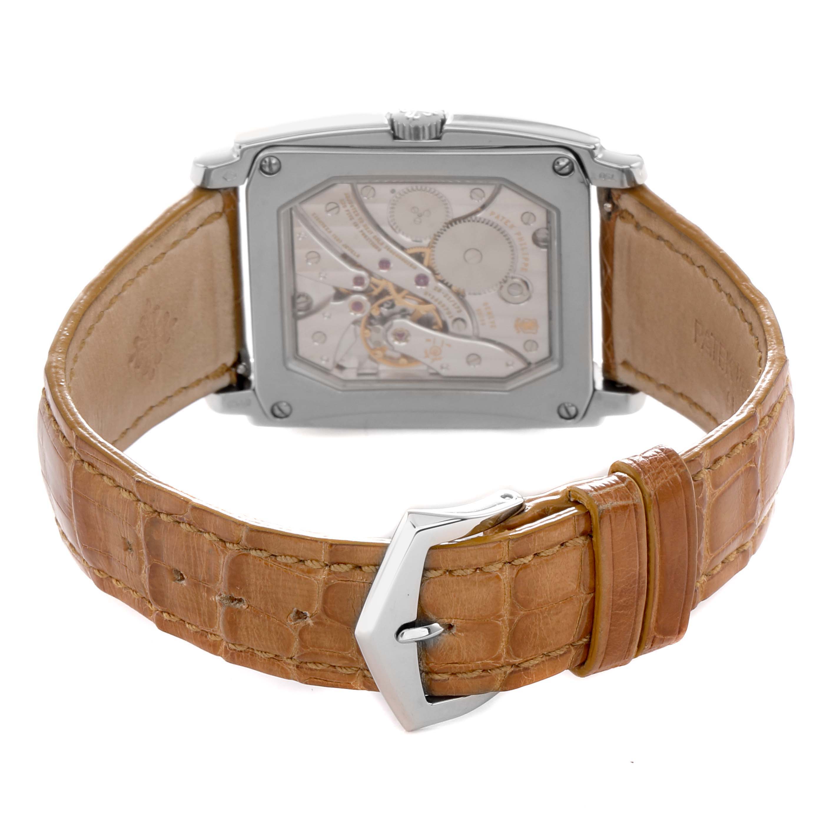 The Patek Philippe Gondolo 5124G Men
s White Gold Brown Dial watch is shown from the back, highlighting its leather strap and visible movement through the transparent case back.