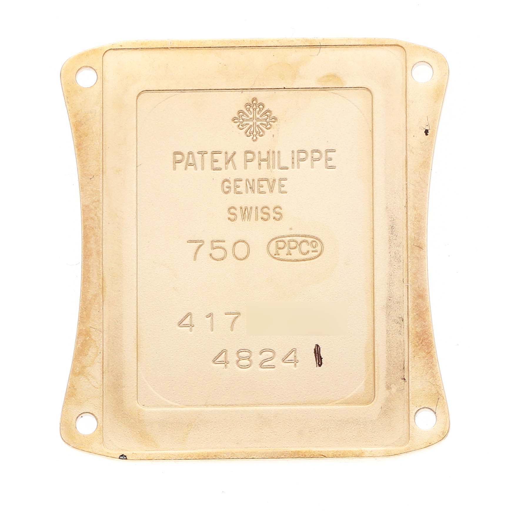 The image shows the back plate of a Patek Philippe Gondolo 4824J Women
s Yellow Gold White Dial watch, displaying engravings and model details.