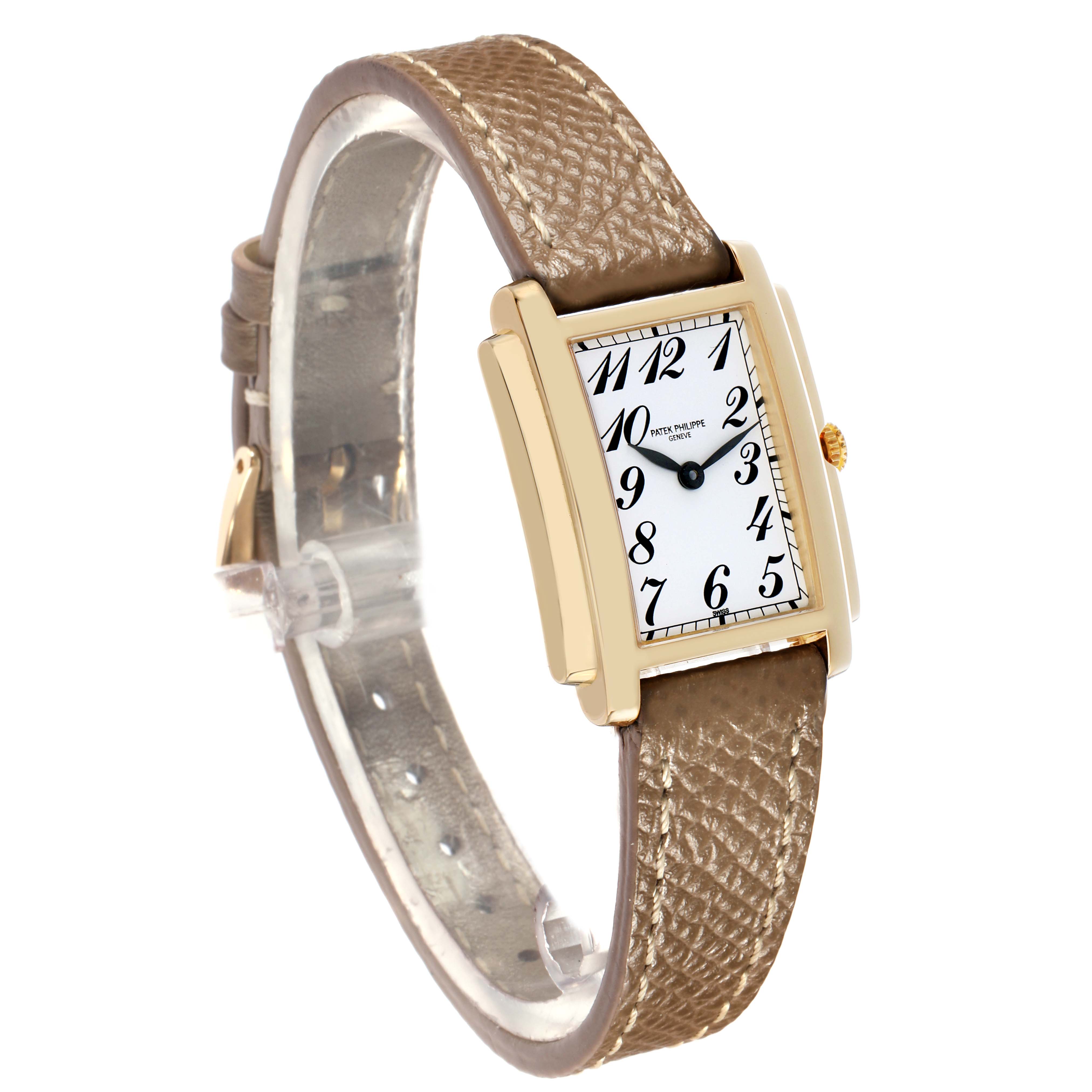 The Patek Philippe Gondolo 4824J Women
s Yellow Gold White Dial watch is shown from a side angle, displaying its rectangular dial, gold case, and textured leather strap.