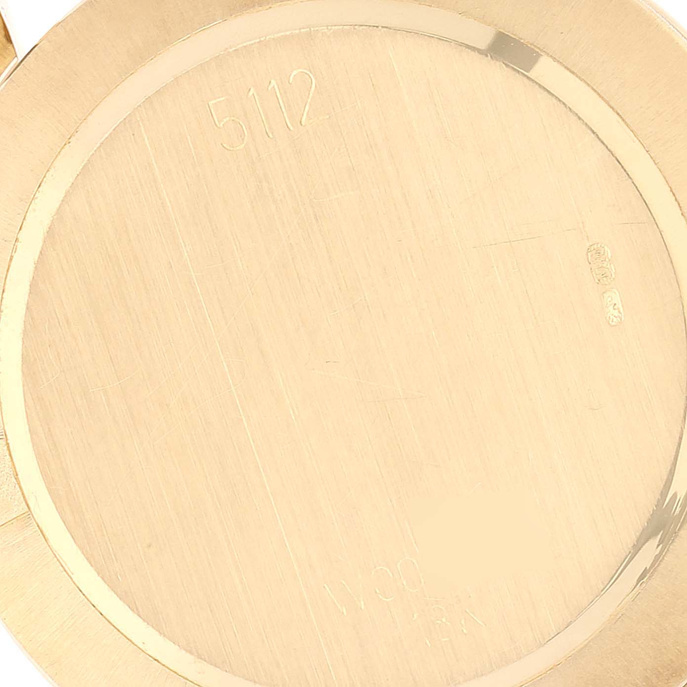 The image shows the back case of a Rolex Cellini 5112 Men's Yellow Gold White Dial 5112 Men's Yellow Gold White Dial model watch, focusing on the engravings and hallmarks.