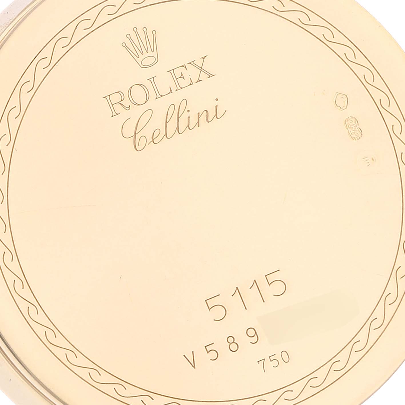This image shows the inside case back of a Rolex Cellini 5115 Men's Yellow Gold Mother of Pearl Dial 5115 Men's Yellow Gold Mother of Pearl Dial model watch, displaying engravings of branding and model details.