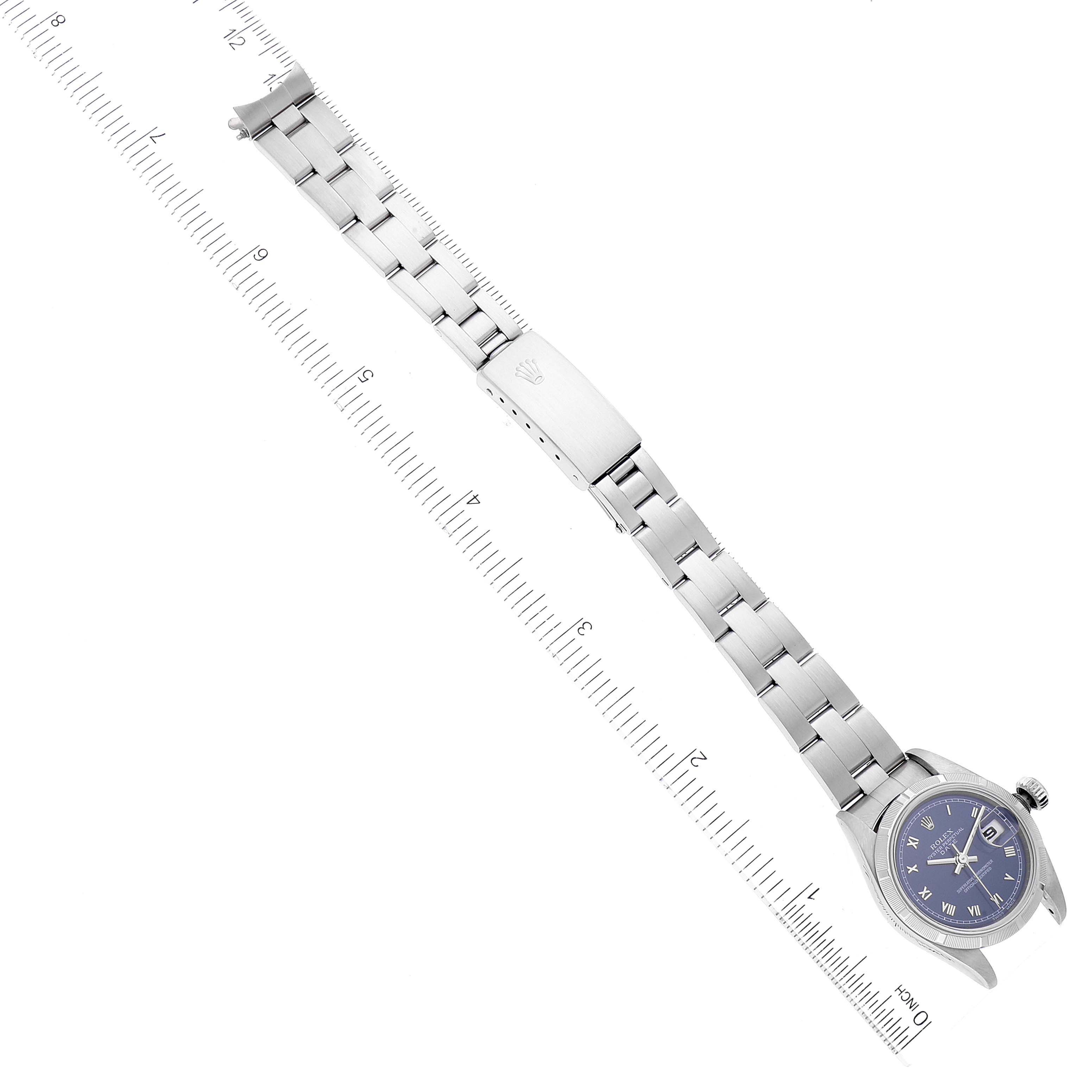 This image shows a top view of a Rolex Date 69190 Women's Stainless Steel Blue Dial 69190 Women's Stainless Steel Blue Dial model watch with a full metal bracelet next to a ruler for scale.