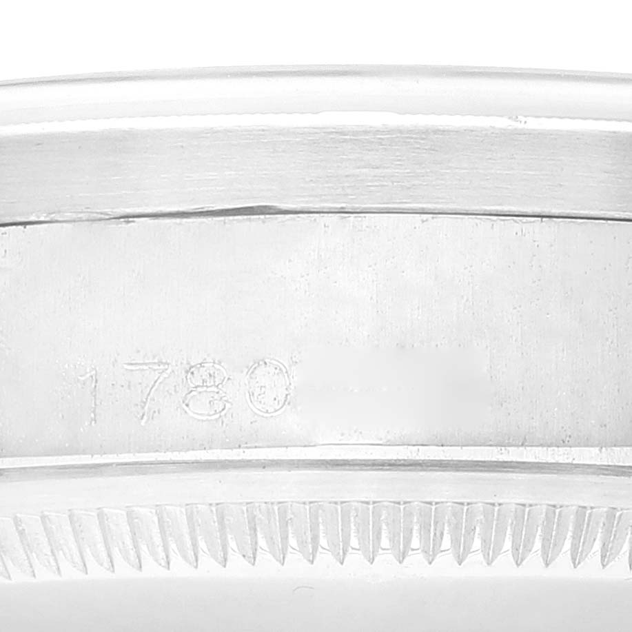 This close-up angle shows the side of the case of a Vintage Collection Rolex watch, highlighting the engraved model number and the bezel teeth.