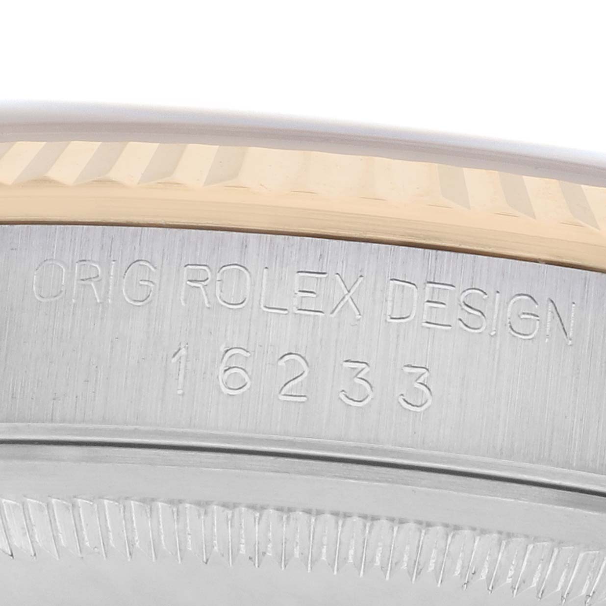 The image shows a close-up of the casing side of a Rolex Datejust 16233 Men
s Steel and Gold (two tone) Champagne Dial, displaying "ORIG ROLEX DESIGN 16233."