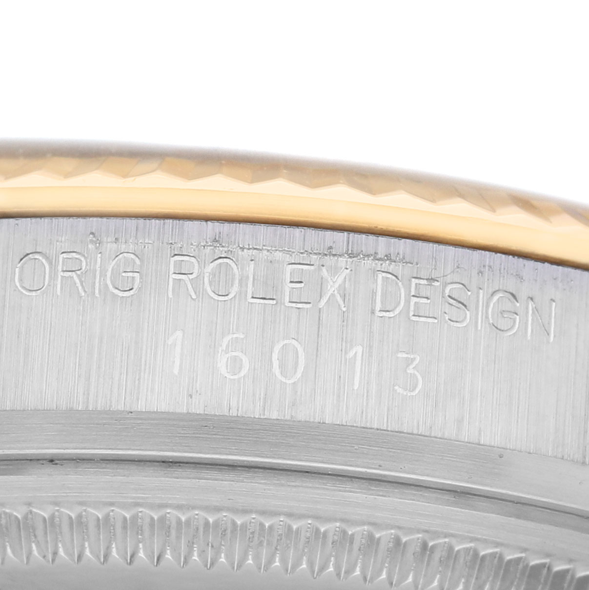 The image shows an angled close-up of the Rolex Datejust 16013 Men's Stainless Steel Champagne Dial model's case side, showcasing engravings and part of the bezel.