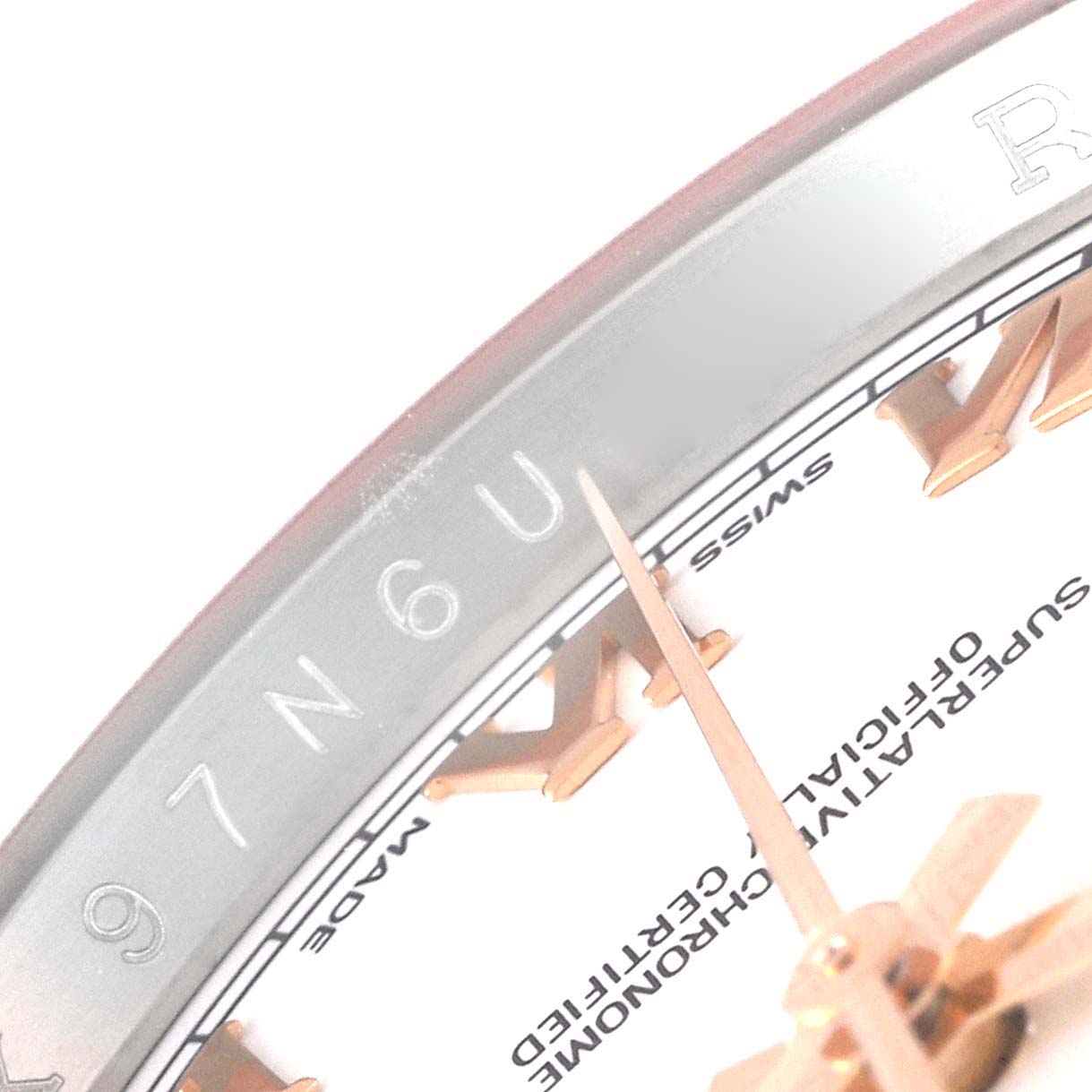 This close-up image shows the Roman numeral markers, part of the bezel, and the minute hand of the Rolex Datejust 116231 Men's Steel and Gold (two tone) White Dial 116231 Men's Steel and Gold (two tone) White Dial watch.