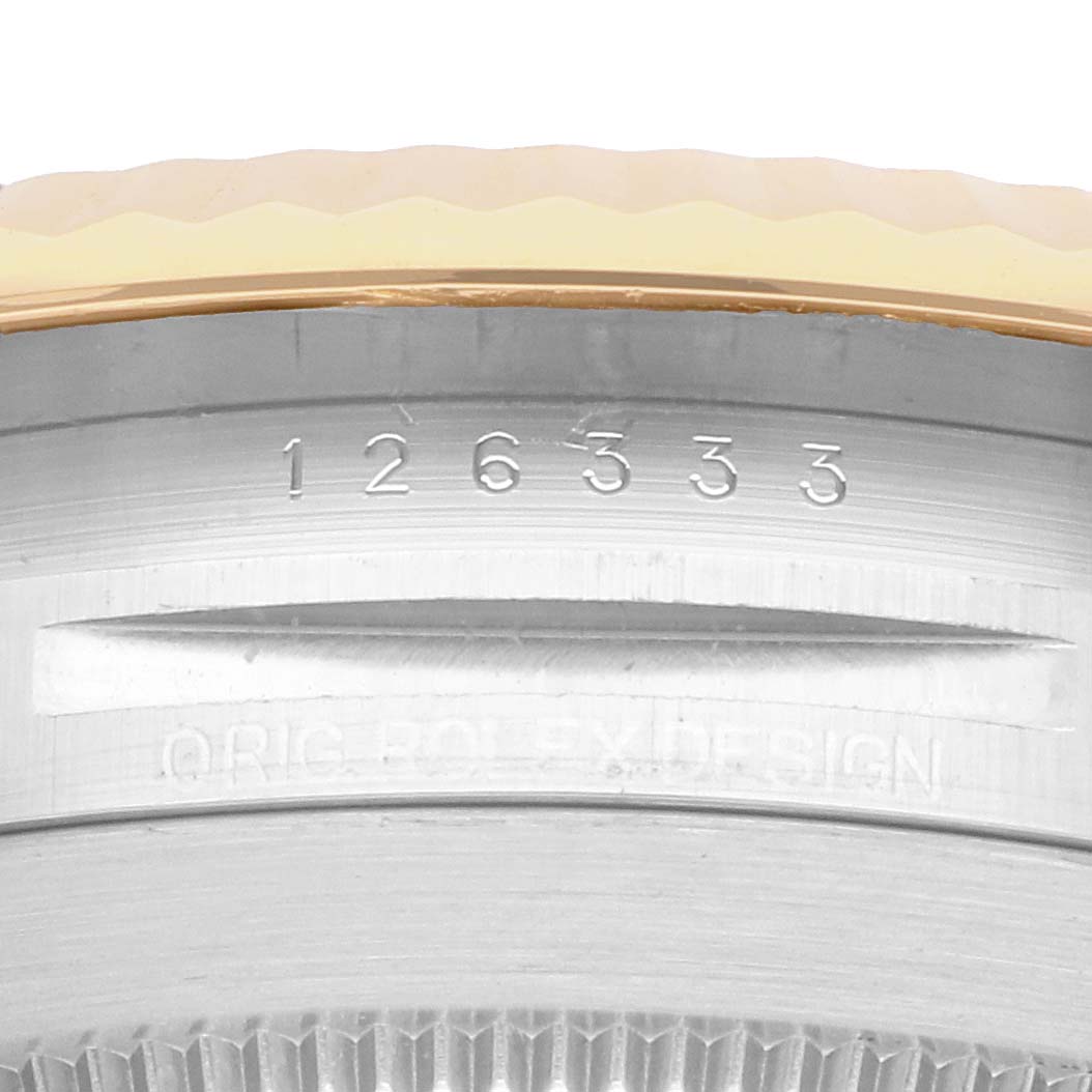 The image shows a close-up of the Rolex Datejust 41 126333 Men
s Steel and Gold (two tone) Champagne Dial
s case edge, featuring the model number and part of the bezel.