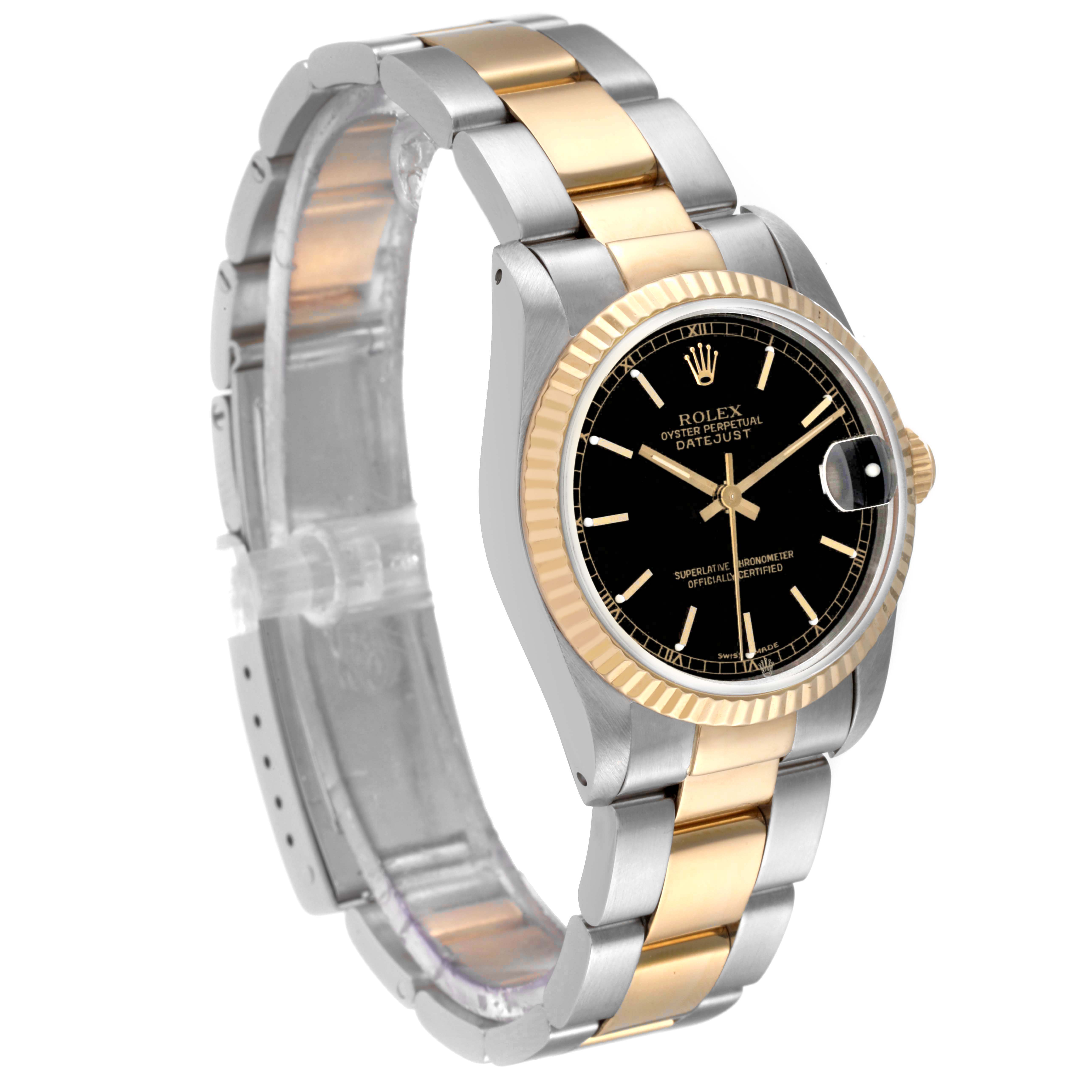 The image shows a Rolex Mid-Size 68273 Women's Steel and Gold (two tone) Black Dial 68273 Women's Steel and Gold (two tone) Black Dial Datejust watch at an angle showcasing its face, bezel, and part of the bracelet.