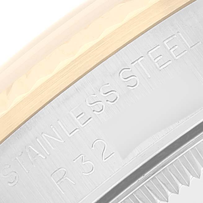 This close-up image shows the "STAINLESS STEEL" engraving and part of the bezel of a Mid-Size Rolex watch.