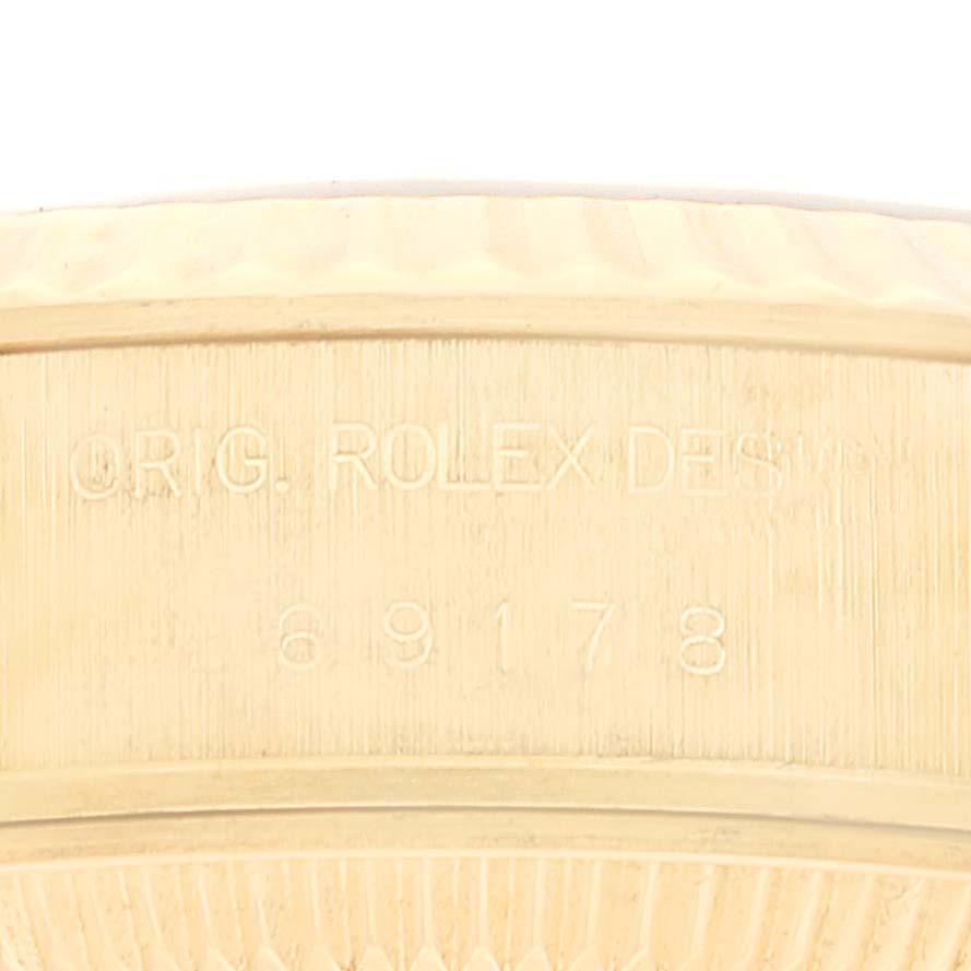 This close-up image shows the engraved model number and design details on the Rolex President 69178 Women's Yellow Gold Champagne Dial 69178 Women's Yellow Gold Champagne Dial watch case side.