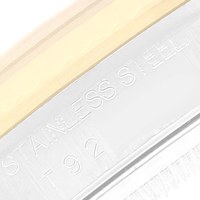 This close-up image shows the engraved "STAINLESS STEEL" inscription on the case of a Rolex Datejust 16233 Men's Steel and Gold (two tone) Champagne Dial 16233 Men's Steel and Gold (two tone) Champagne Dial model.