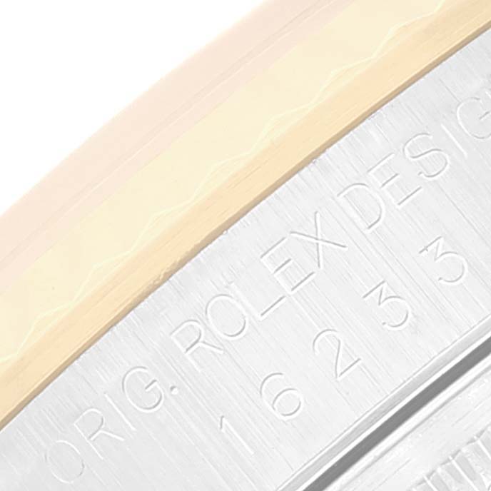 This close-up image shows the engraved case side and bezel of a Rolex Datejust 16233 Men's Steel and Gold (two tone) Champagne Dial 16233 Men's Steel and Gold (two tone) Champagne Dial watch.