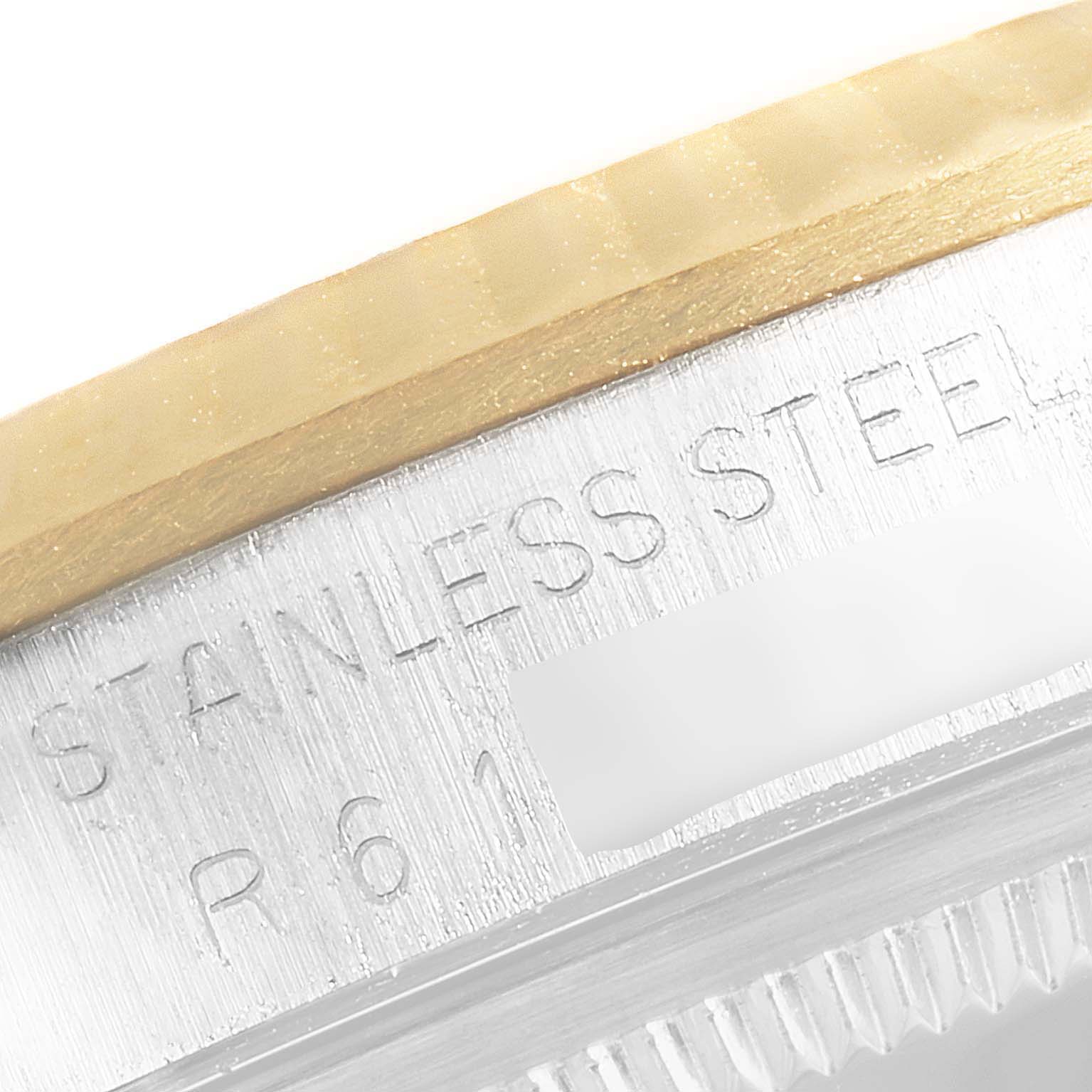 The image shows a close-up of the engraved stainless steel outer casing of a Rolex Datejust 16233 Men
s Steel and Gold (two tone) Champagne Dial 16233 Men
s Steel and Gold (two tone) Champagne Dial watch.