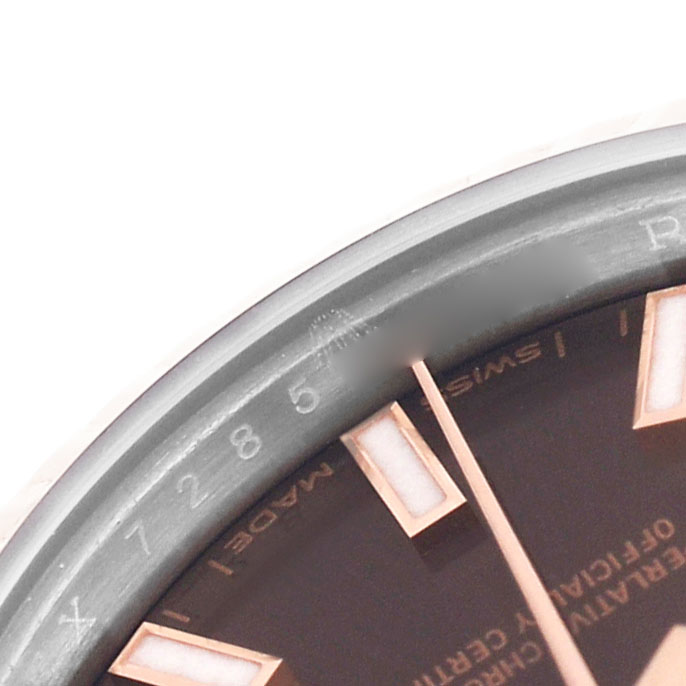 The image shows a close-up of the dial and bezel of a Rolex Datejust 279171 Women's Steel and Gold (two tone) Brown Dial watch, highlighting the hour markers and part of the script.