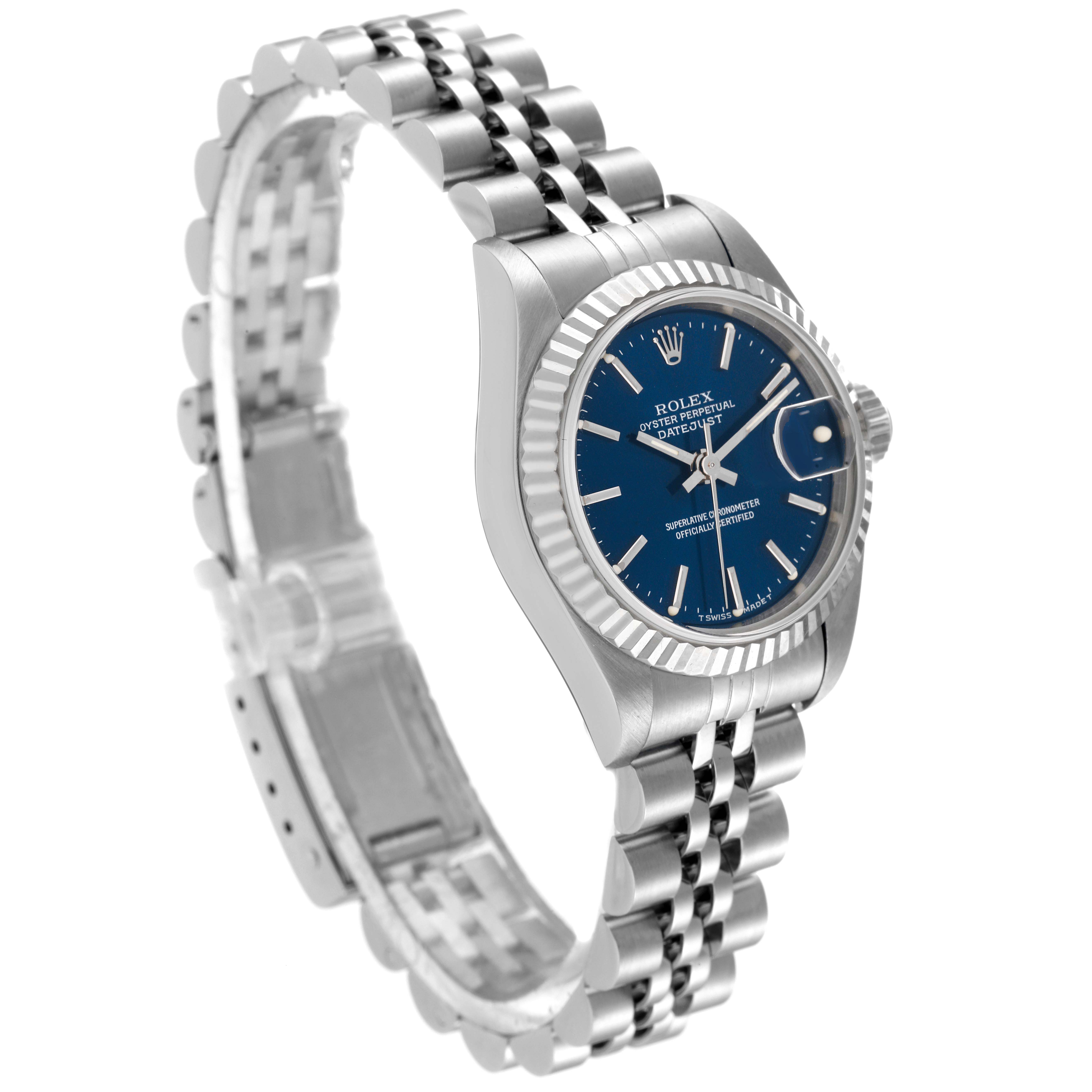 The image shows a side angle of the Rolex Datejust 69174 Women's Stainless Steel Blue Dial 69174 Women's Stainless Steel Blue Dial watch, displaying its blue dial, fluted bezel, and the jubilee bracelet.