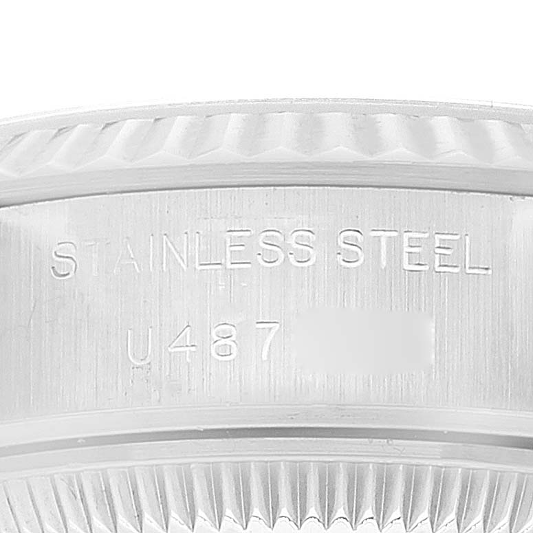 This close-up image shows the edge case and inner bezel of a Rolex Datejust 69174 Women's Stainless Steel Blue Dial 69174 Women's Stainless Steel Blue Dial watch, featuring the "STAINLESS STEEL" engraving.