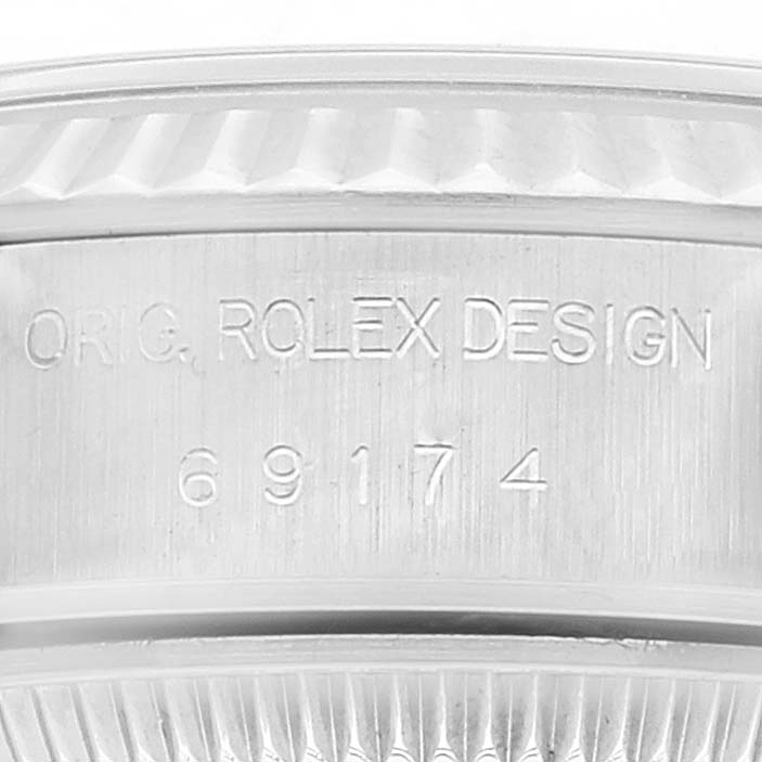 This is a close-up of the case engraving of a Datejust model by Rolex, showing the model number 69174.