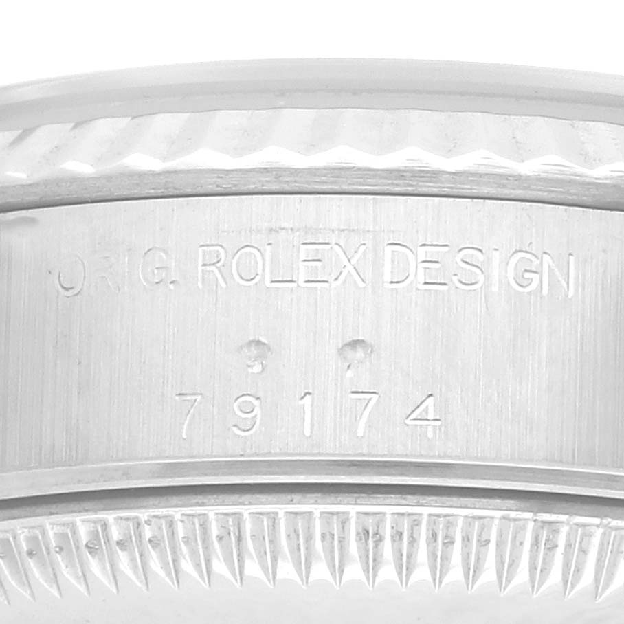 The image shows a close-up of the Rolex Datejust 79174 Women
s Stainless Steel Pink Dial model
s case side engraving, displaying the design and model numbers.