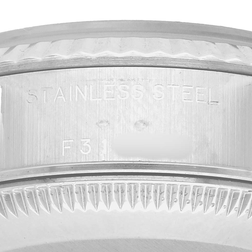 The image shows a close-up of the stainless steel case with the serial number of a Rolex Datejust 79174 Women
s Stainless Steel Pink Dial watch.