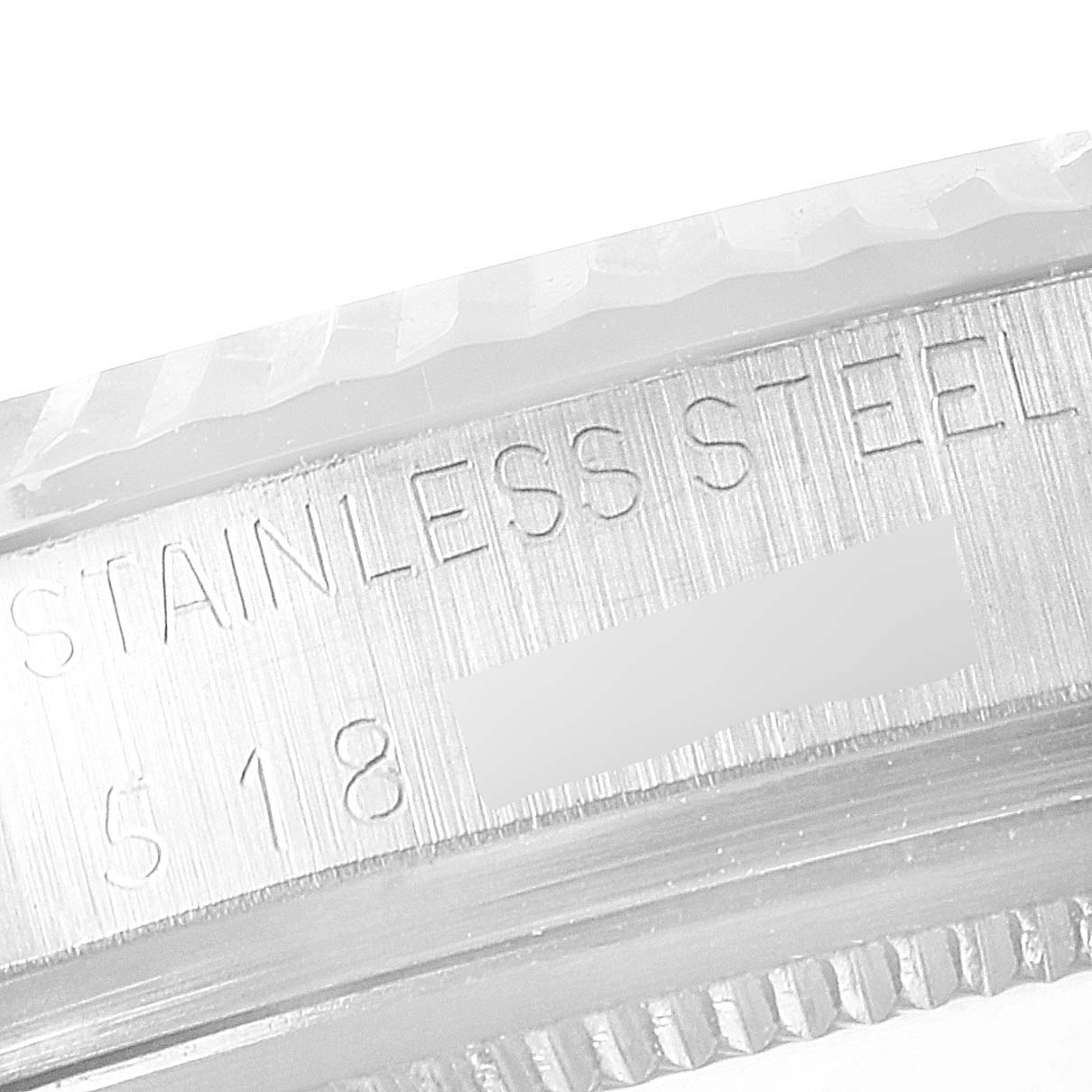 The image shows a close-up of the case back edge of a Rolex Vintage Collection 1601 Men's Stainless Steel Grey Dial 1601 Men's Stainless Steel Grey Dial watch, highlighting the "STAINLESS STEEL" engraving.