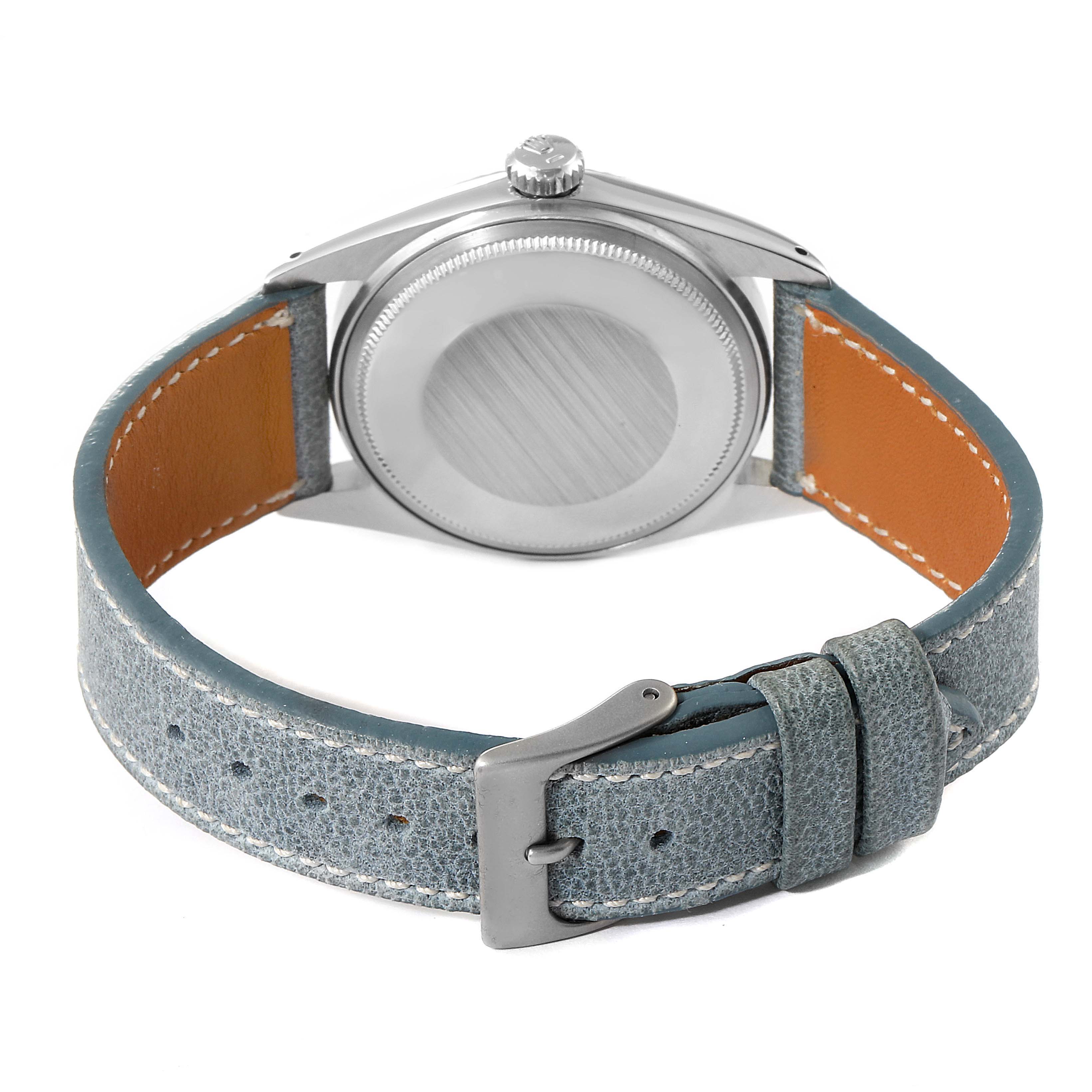 The image shows the back view of a Rolex Vintage Collection 1601 Men's Stainless Steel Grey Dial 1601 Men's Stainless Steel Grey Dial watch with a blue leather strap and silver buckle.
