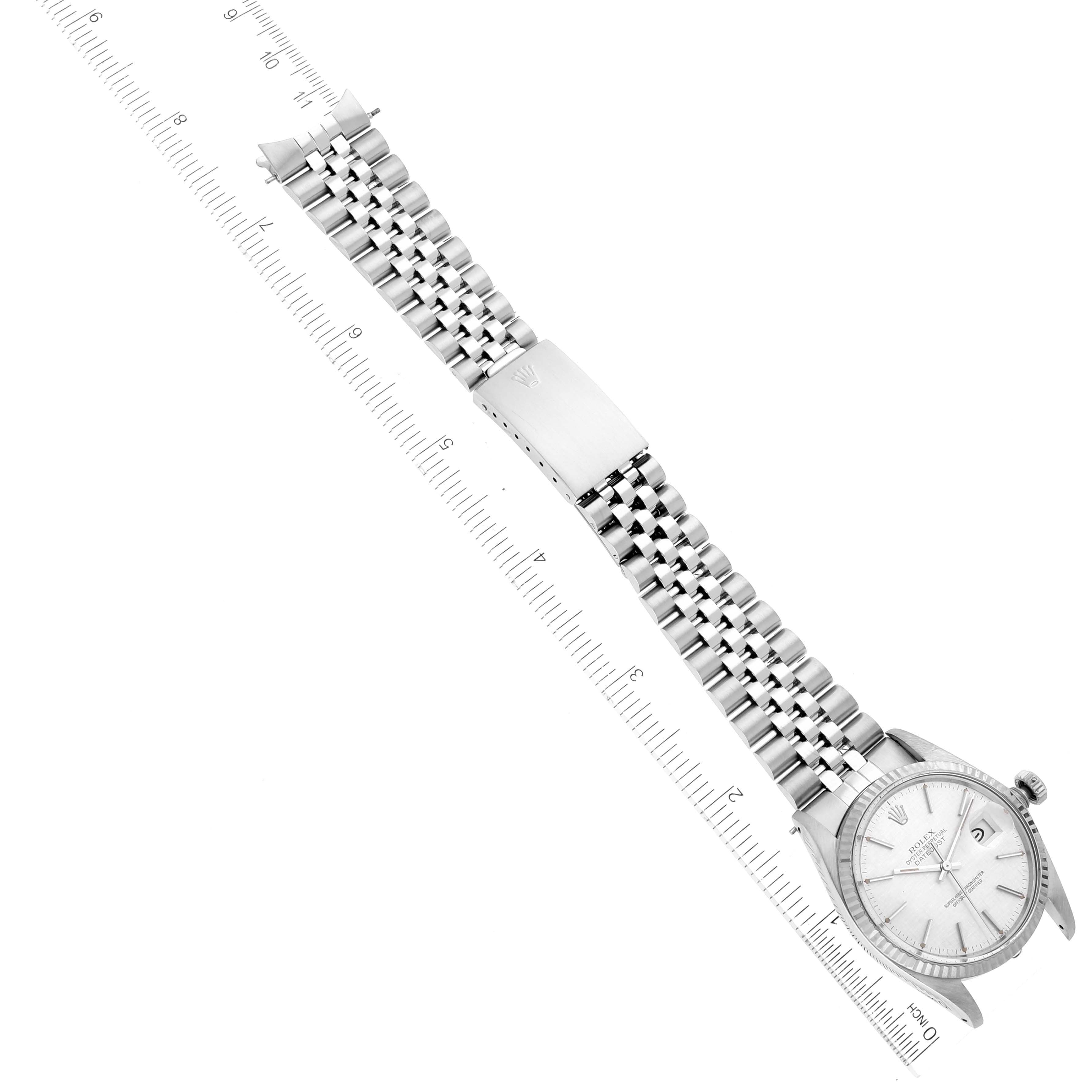 The image shows a Vintage Collection model Rolex watch laid flat with its band fully extended alongside a measuring scale.