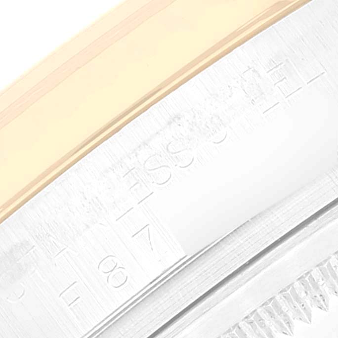 This close-up image shows the engraved details on the outer edge of the bezel and case of a Rolex Datejust 116233 Men's Steel and Gold (two tone) Blue Dial 116233 Men's Steel and Gold (two tone) Blue Dial watch.